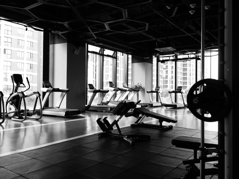 Modern gym with strength and cardio equipment, representing the structured training environments contrasted with the natural development of world-class footballers.