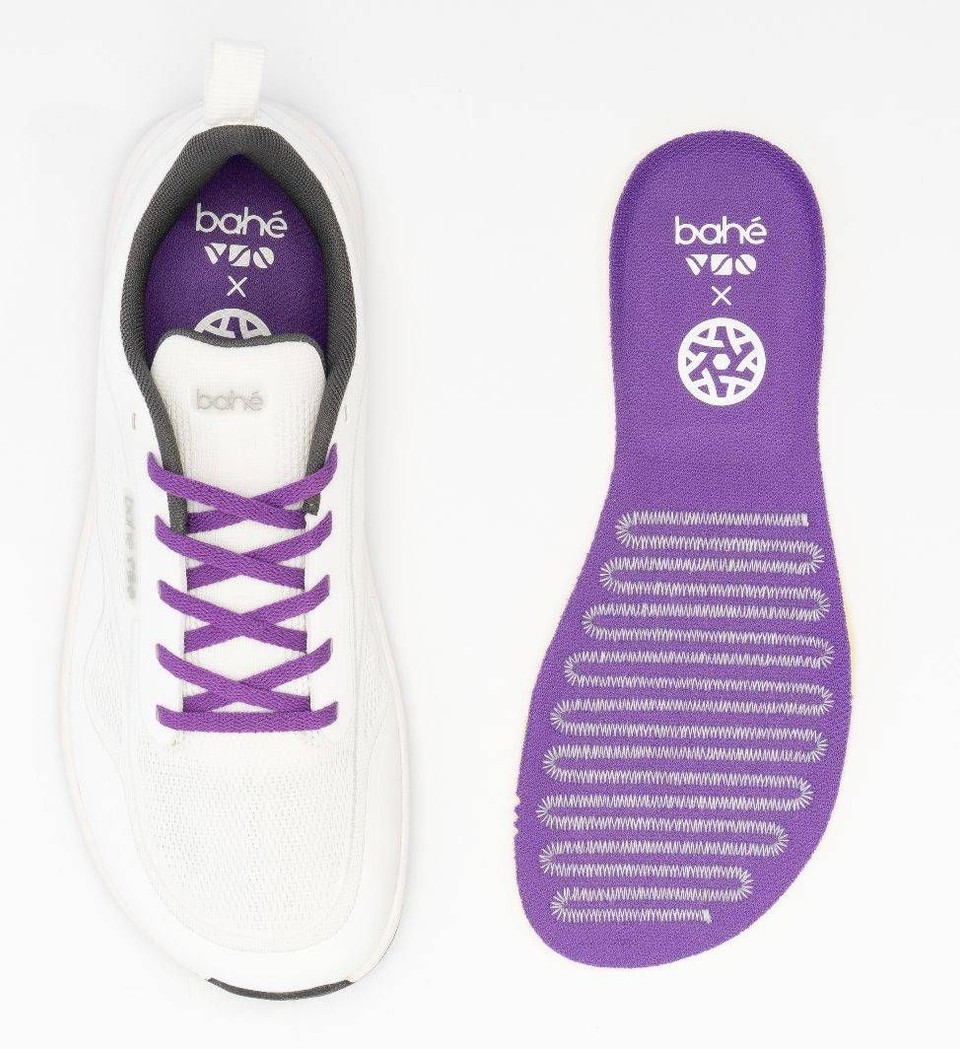 White athletic shoe displayed beside a custom purple Bahé × Football Entangled insole, highlighting the collaboration focused on foot function, movement, and athletic performance.