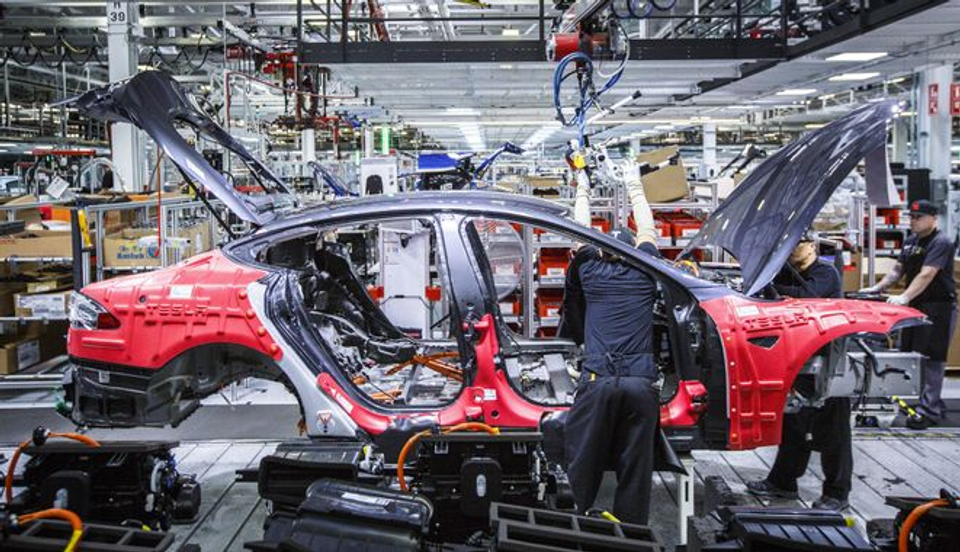 Car being assembled on a factory production line, illustrating the article's comparison that world-class footballers are naturally developed rather than manufactured.