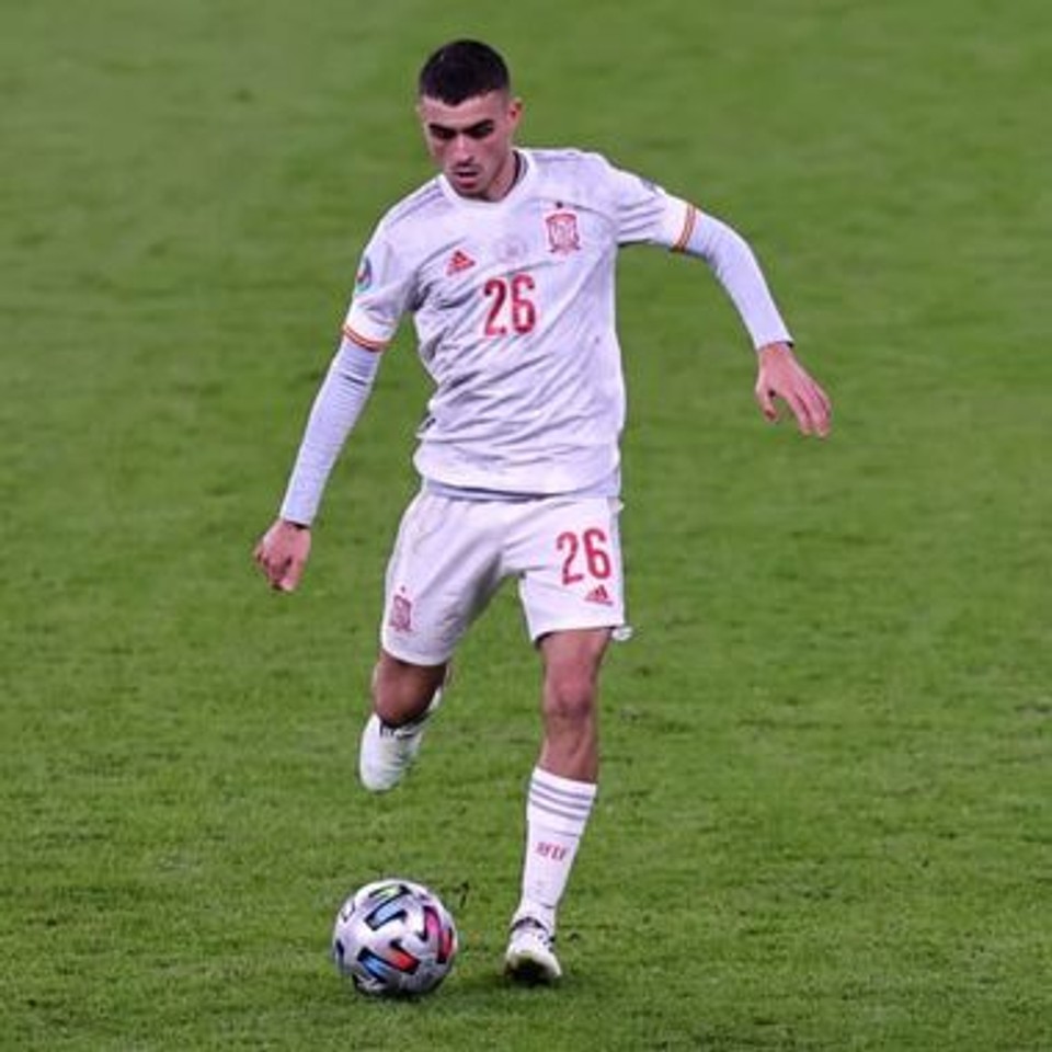 Professional footballer Pedri controls the ball during an international match for Spain, demonstrating the fluid movement, balance, and coordination characteristic of elite football performance.