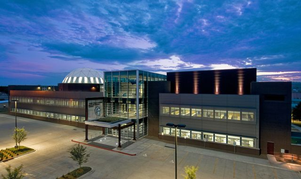 Modern school building representing indoor environments where children spend much of their time, contrasting with the outdoor childhood experiences discussed in this article.