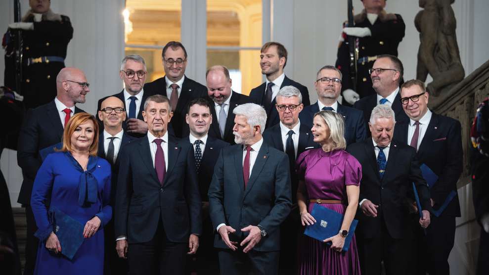 Members of Andrej Babiš's new cabinet stand with President Petr Pavel on a staircase at Prague Castle.