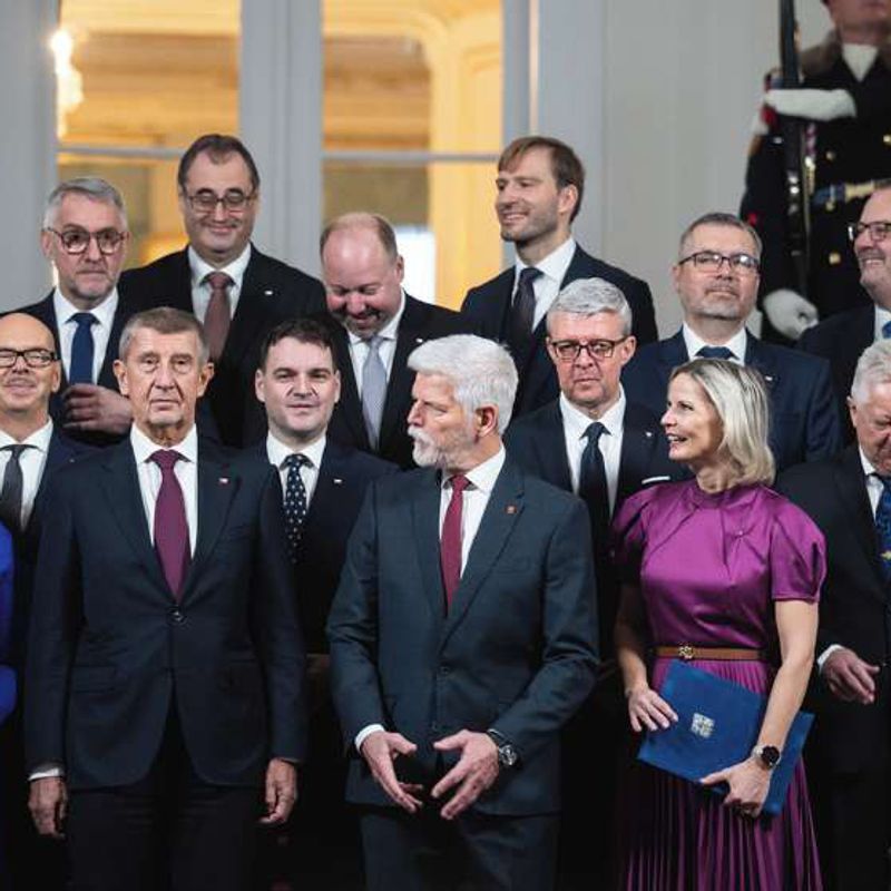 Members of Andrej Babiš's new cabinet stand with President Petr Pavel on a staircase at Prague Castle.