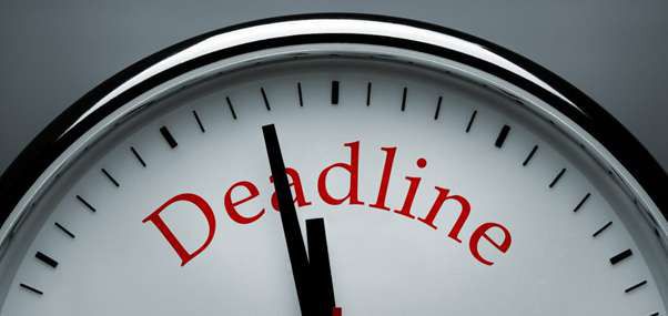 A clock face with the word “Deadline” printed on it, its hands just before twelve.