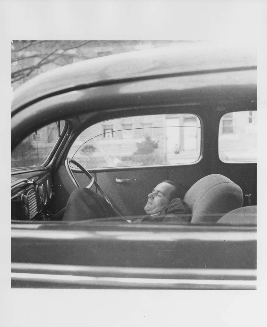 John Evarts asleep in a car.