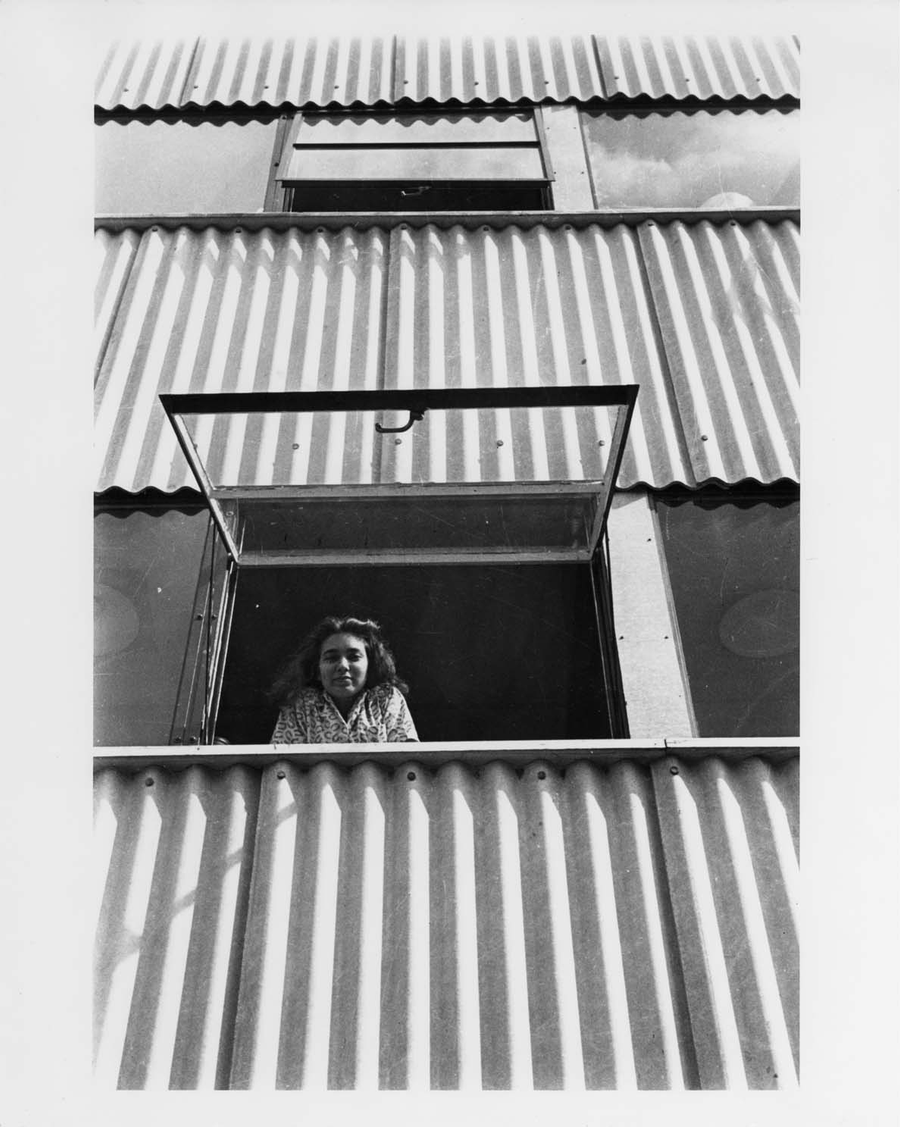 Dodie Dora Harrison leaning out a Studies Building window, Lake Eden campus, ca. 1942.