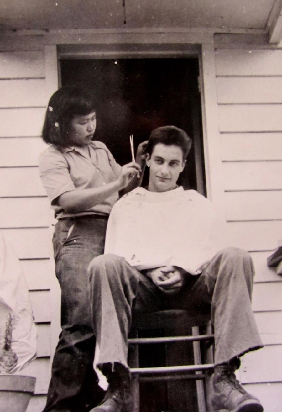 Ruth Asawa cutting Jerrold Levy's hair.