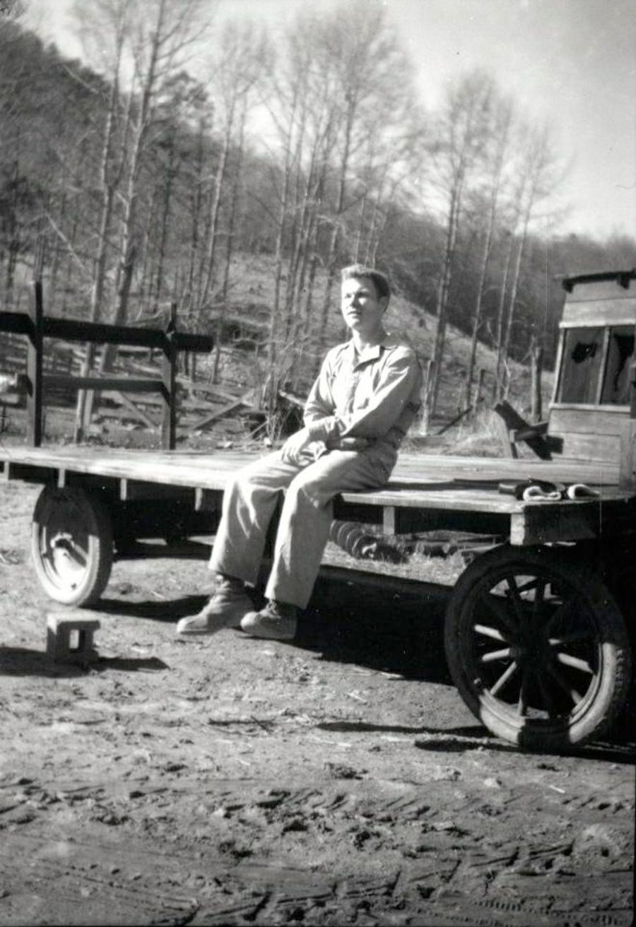 Trueman MacHenry sitting on a hay wagon at the Lake Eden farm, circa 1951. 