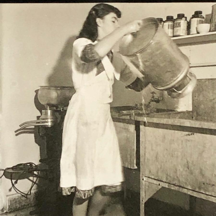 Ati Gropius cleaning a milk container.