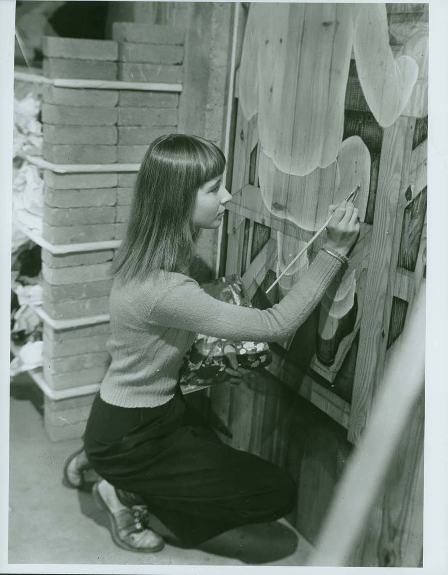 Faith Murray painting door to weaving room.