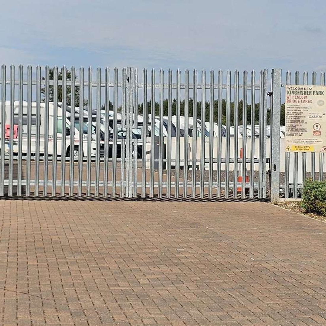 The palisade entrance gates and the Kingfisher Park welcome sign