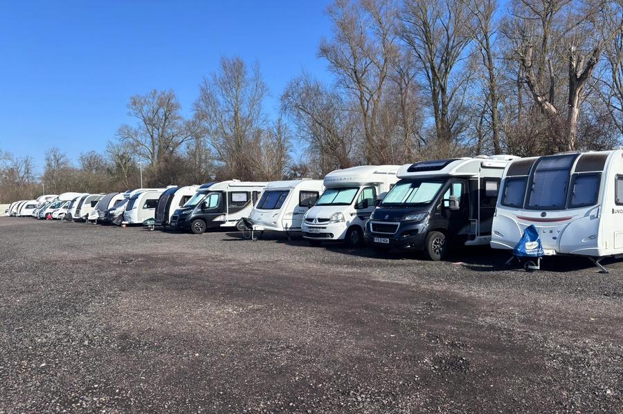 A long row of motorhomes and campervans on allocated pitches