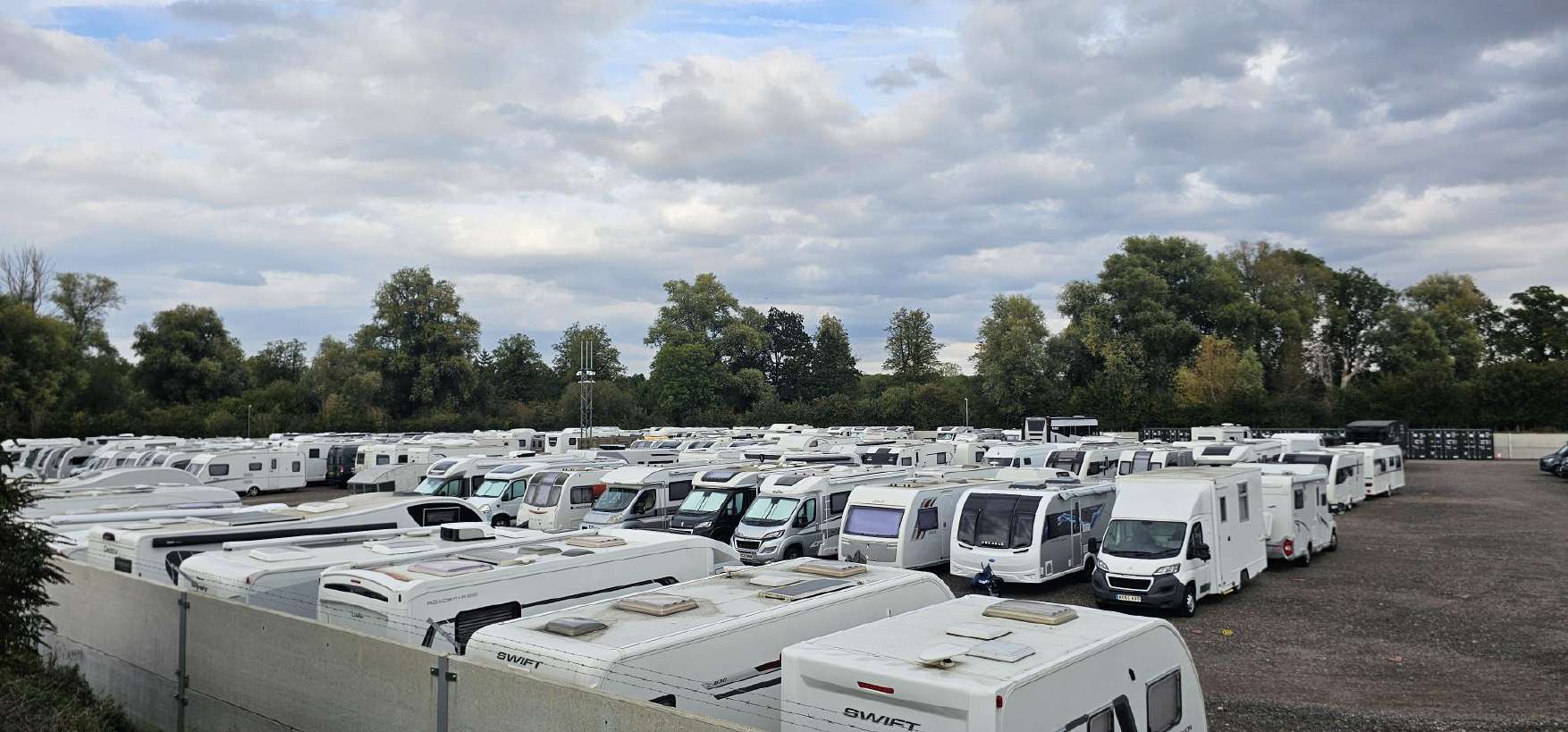 A wide view across the compound, with caravans and motorhomes on gravel hardstanding