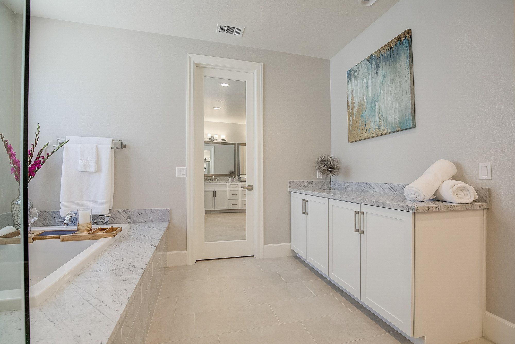 Primary bathroom with a white vanity and abstract art, Costa Mesa