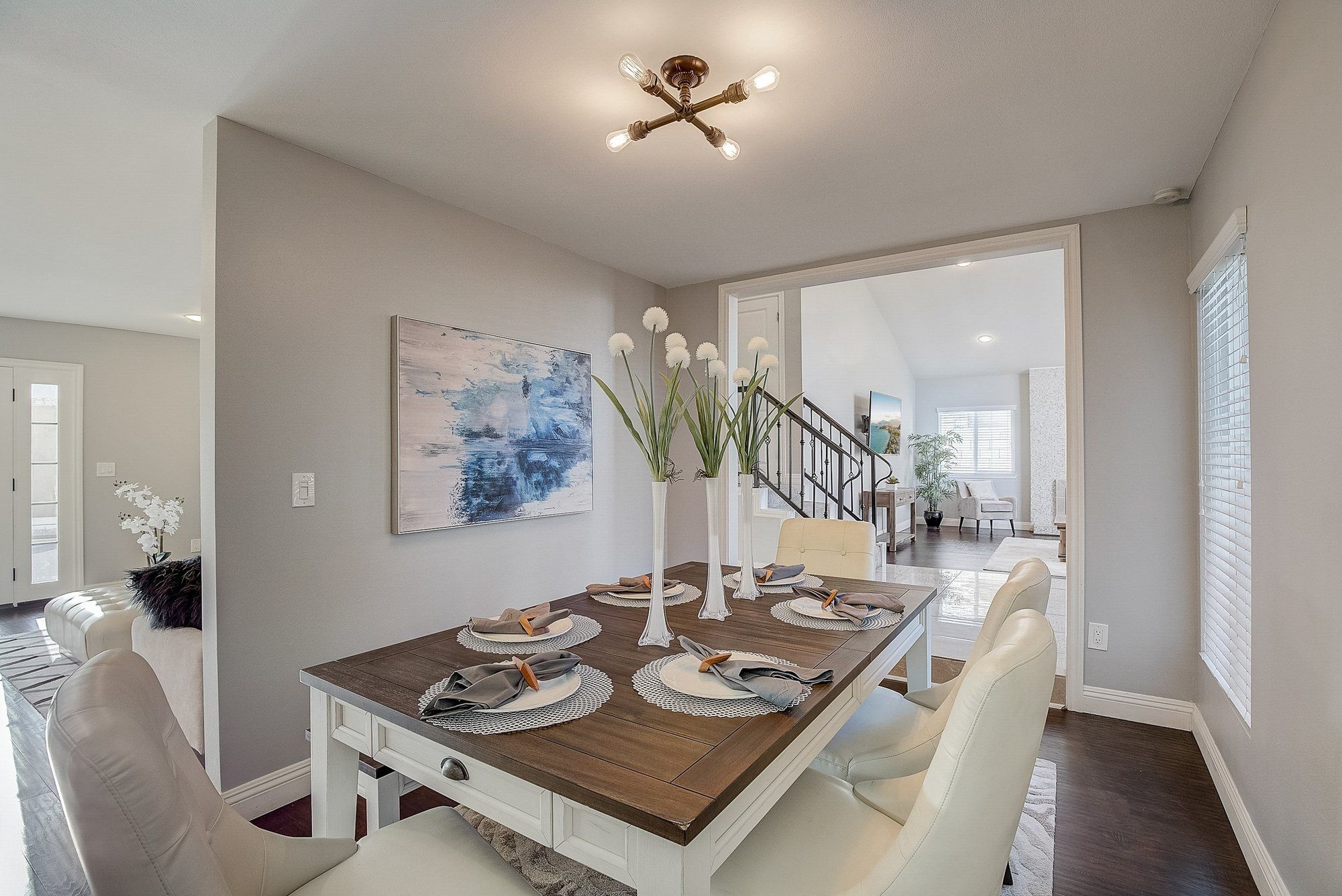 Dining table set for four, with the stairs beyond, Huntington Beach