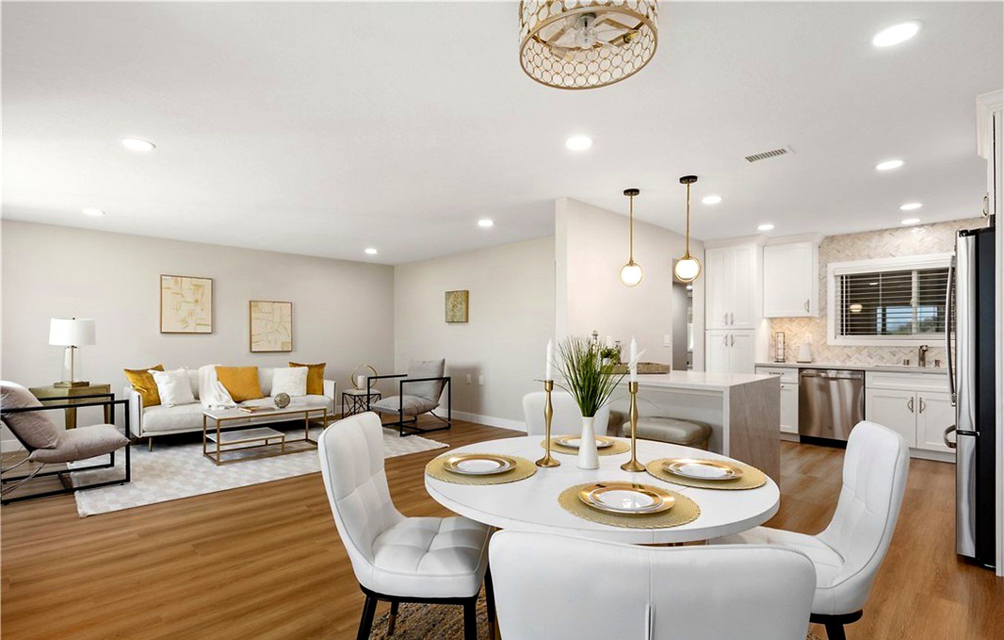 Dining table set for four, with the living room and kitchen behind, Laguna Woods