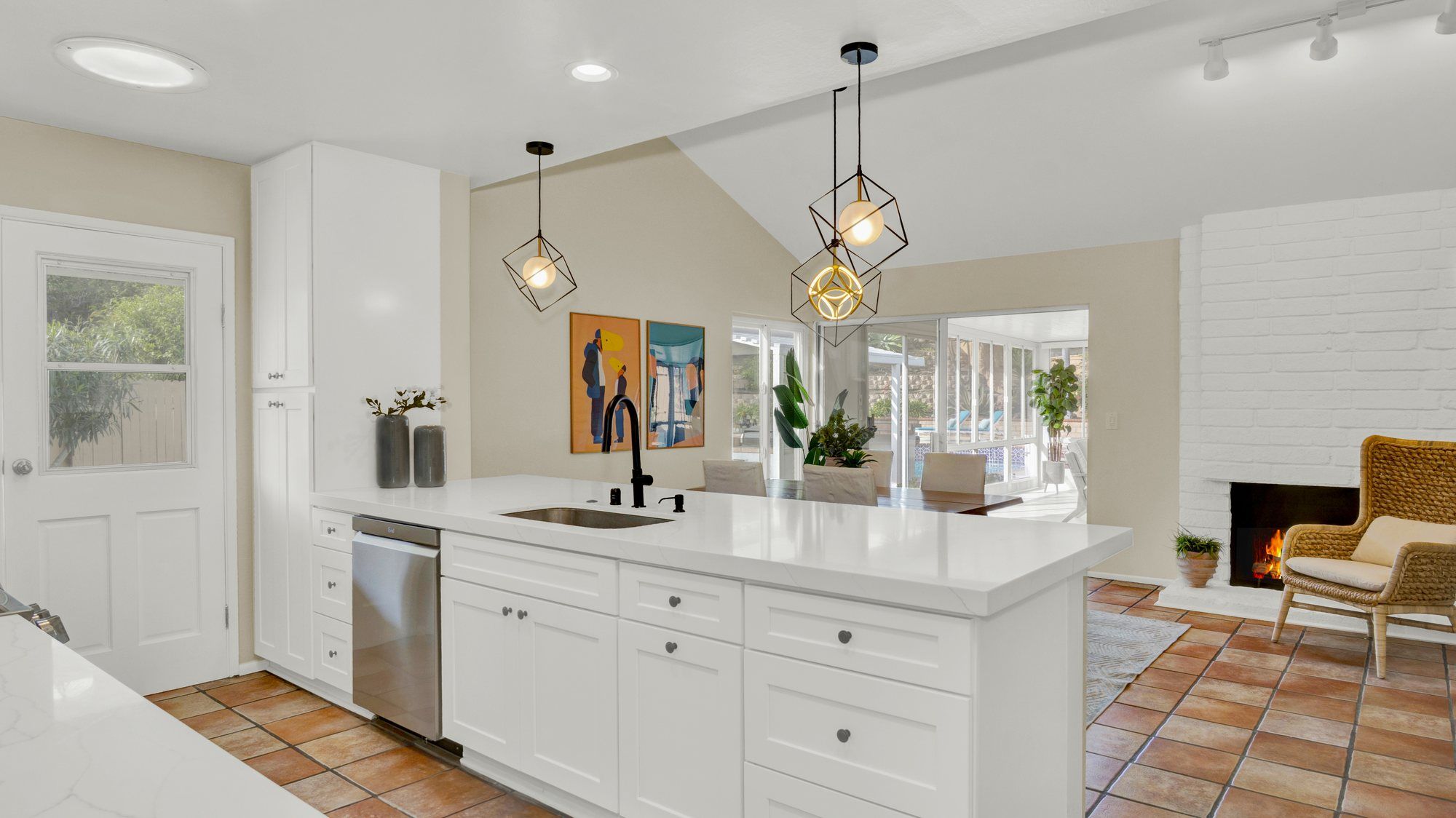 White kitchen with geometric pendant lights and a quartz peninsula, Dana Point