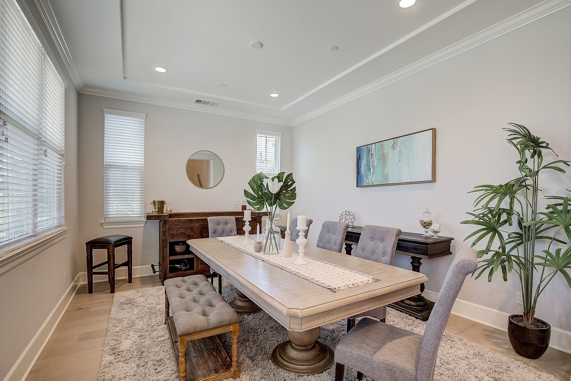 Long light-wood dining table with gray tufted chairs, Costa Mesa