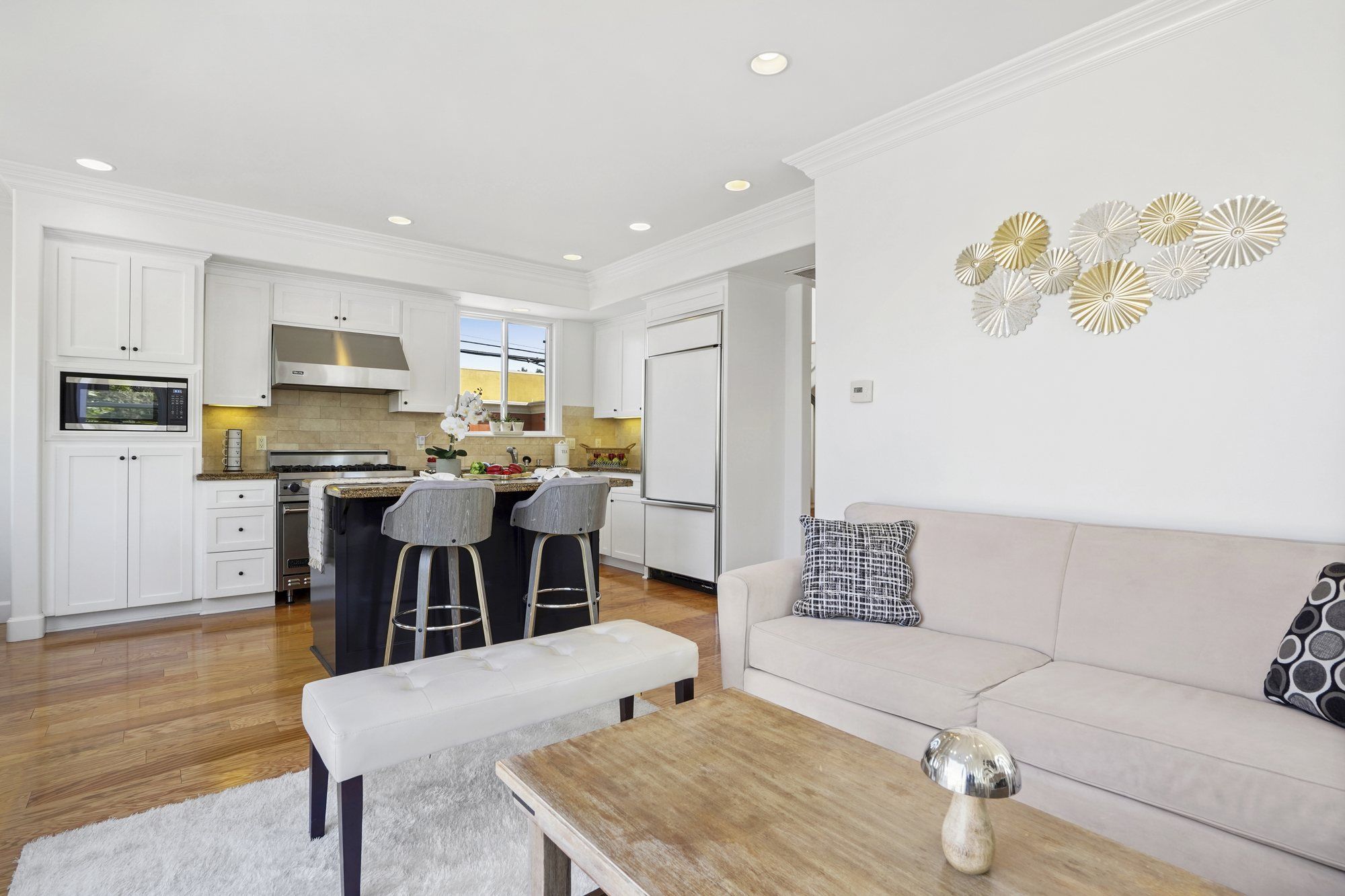 Living room open to the kitchen and its bar stools, Newport Beach