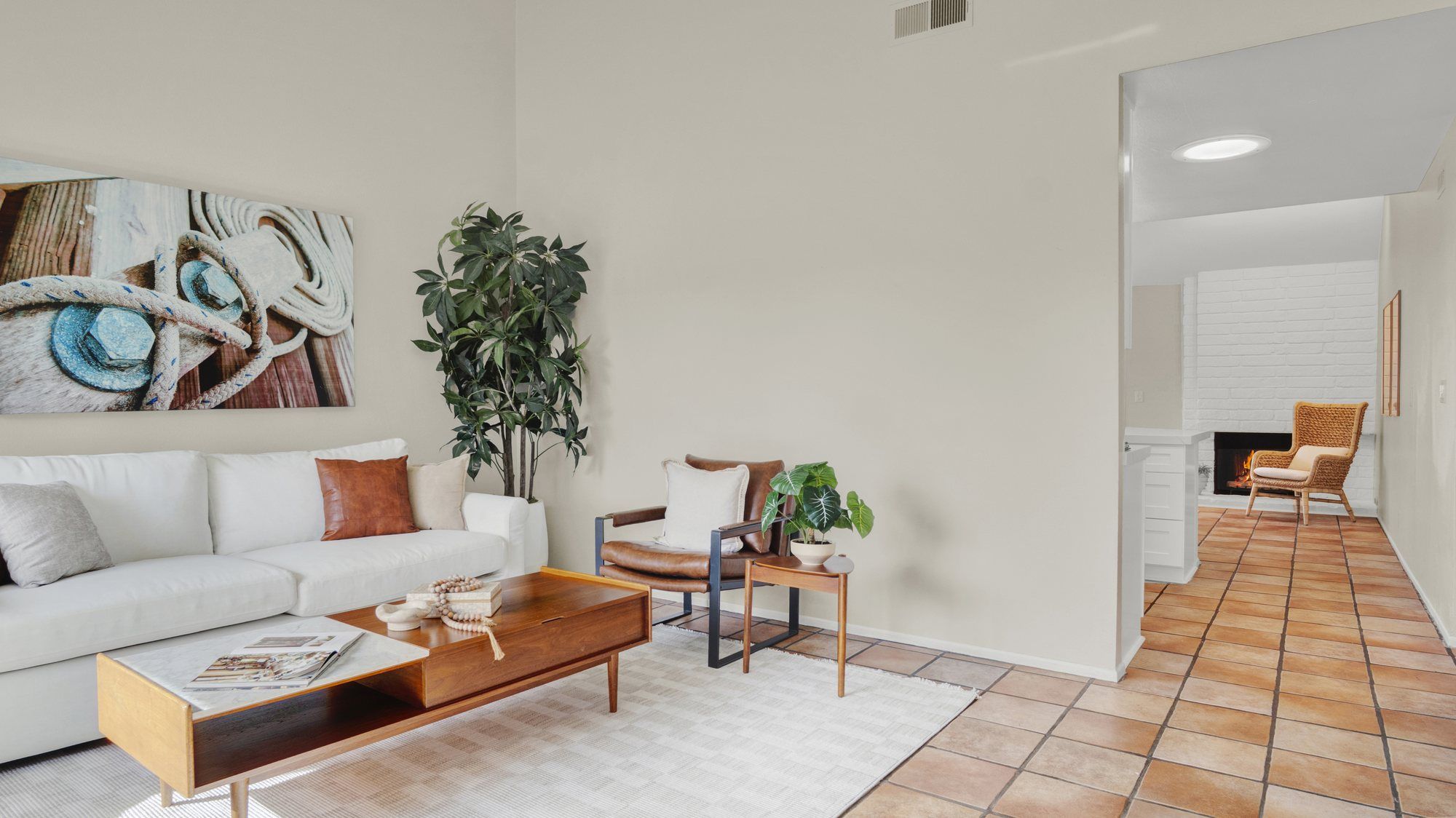 White sofa and a leather accent chair under a vaulted ceiling, Dana Point