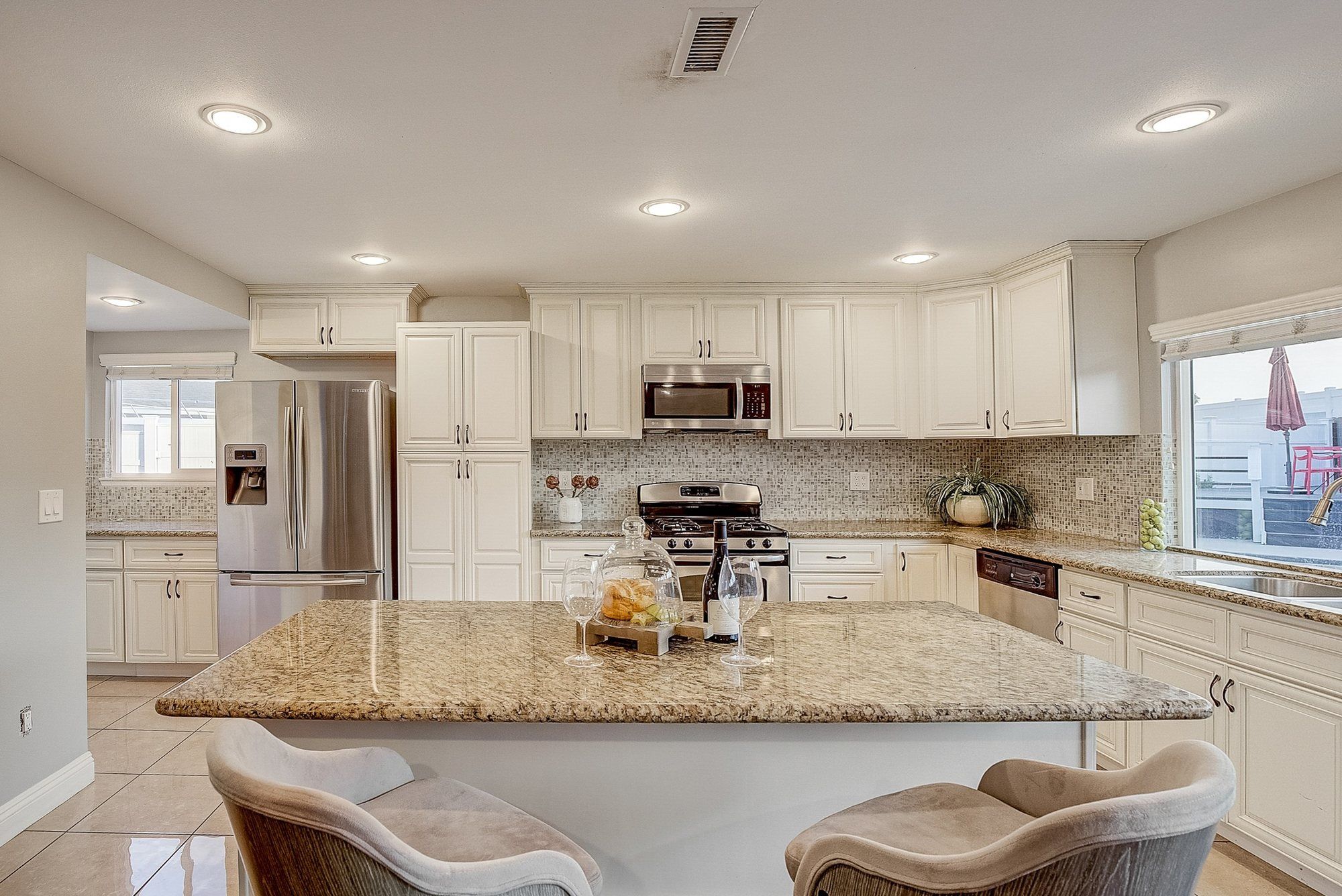 Granite island with two upholstered stools, Huntington Beach