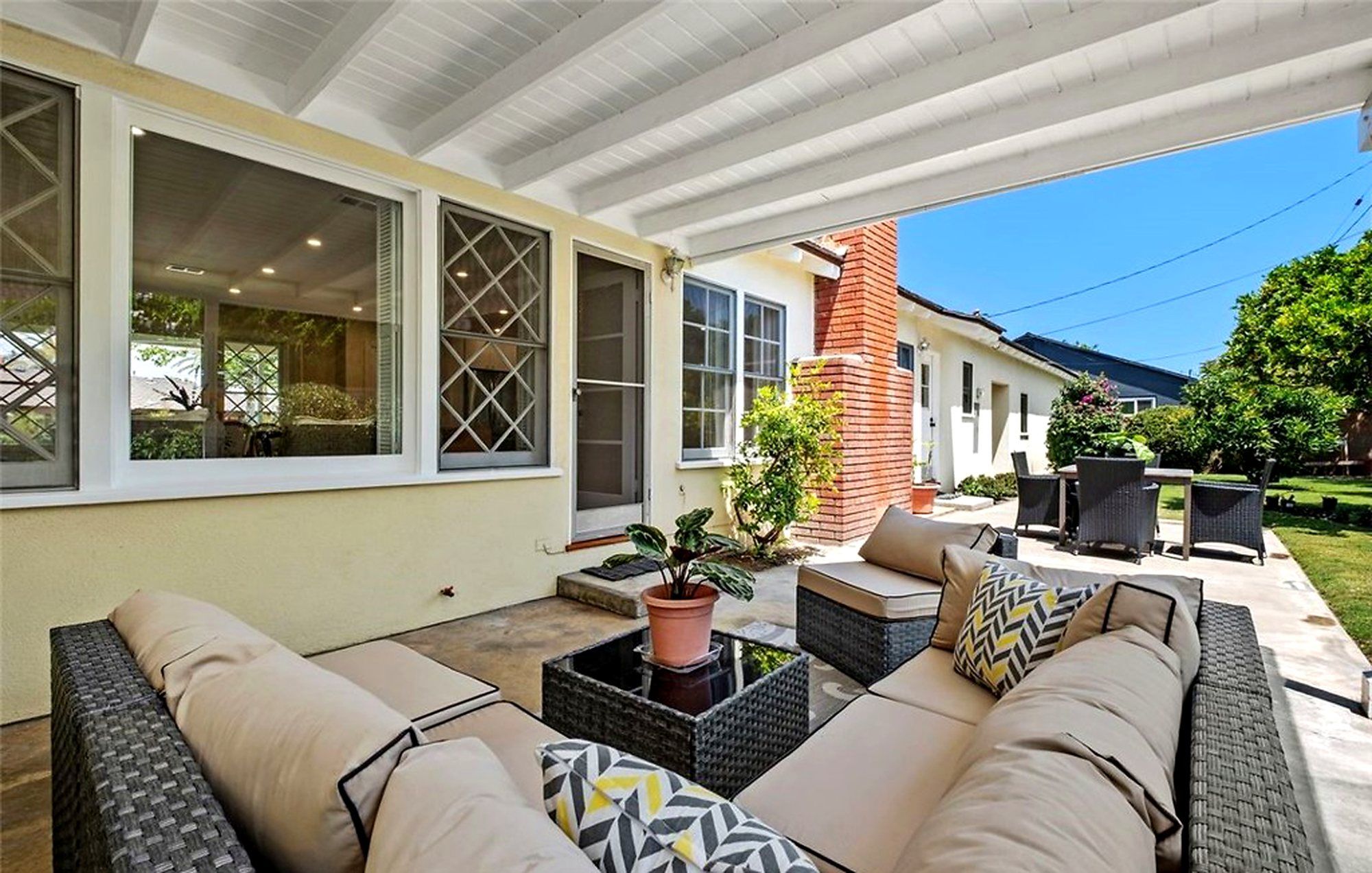 Covered patio with a wicker sectional and patterned pillows, Santa Ana