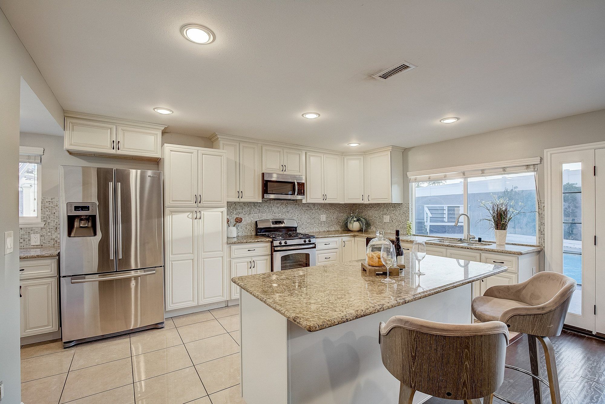 Kitchen with cream cabinets, a granite island and stainless appliances, Huntington Beach