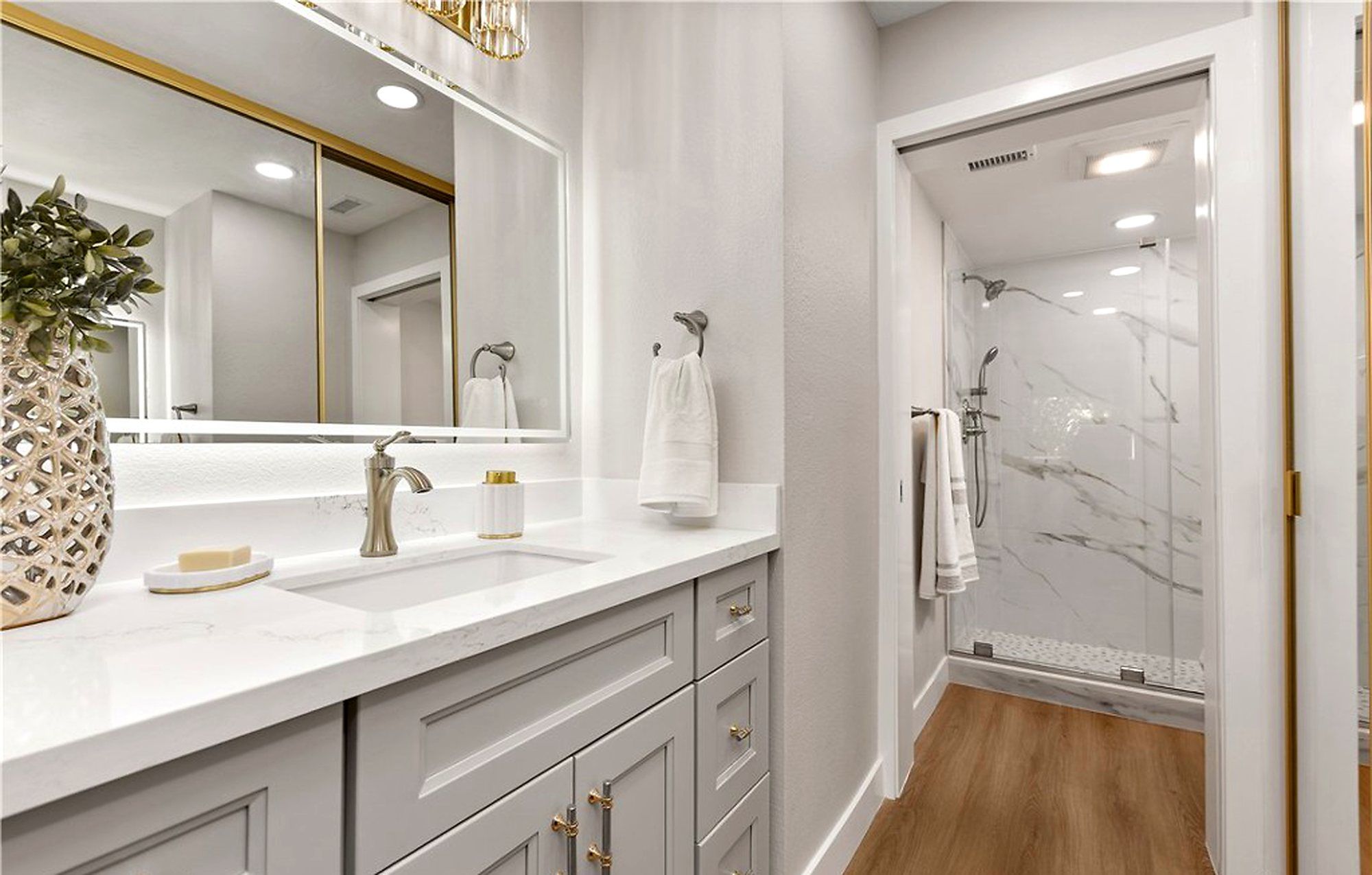 Bathroom with a gray vanity and a marble-look shower, Laguna Woods