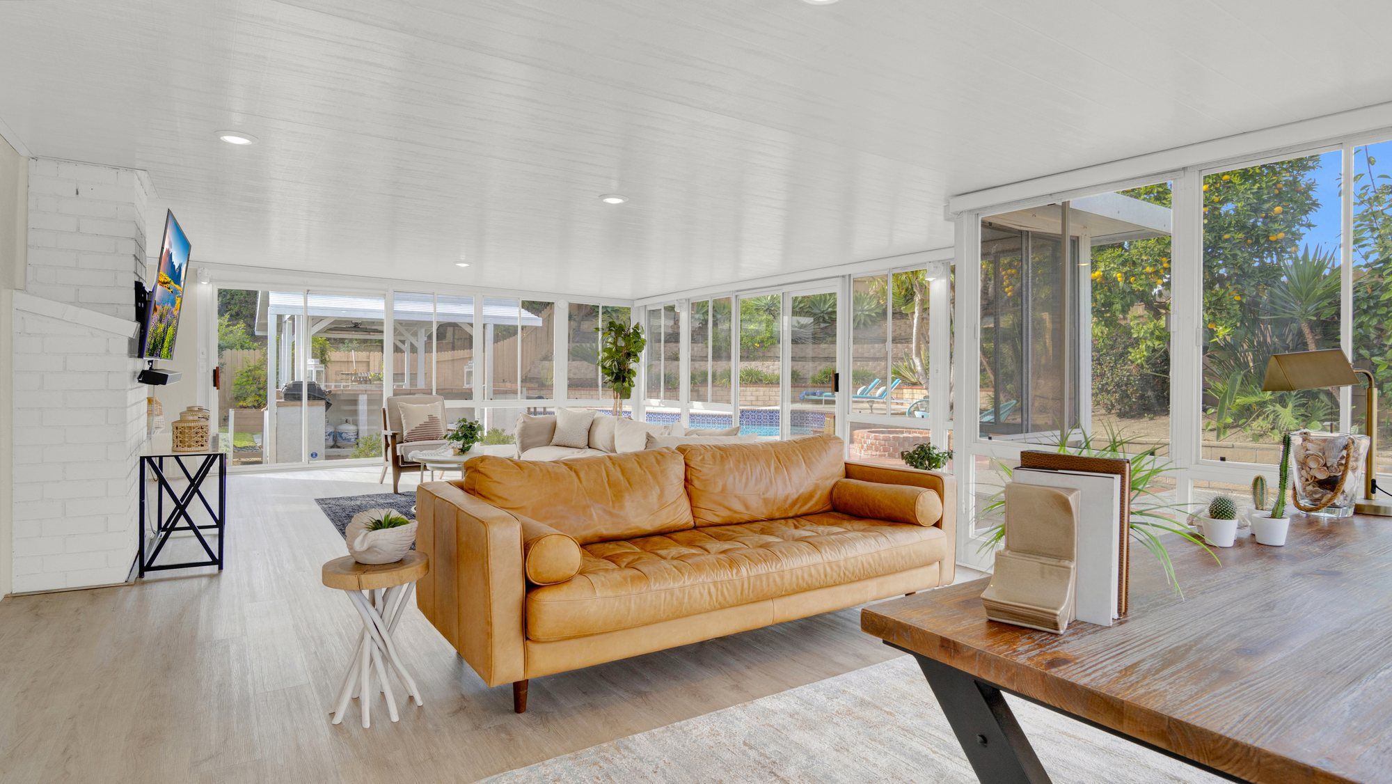 Tan leather sofa in the sunroom, looking out to the pool, Dana Point