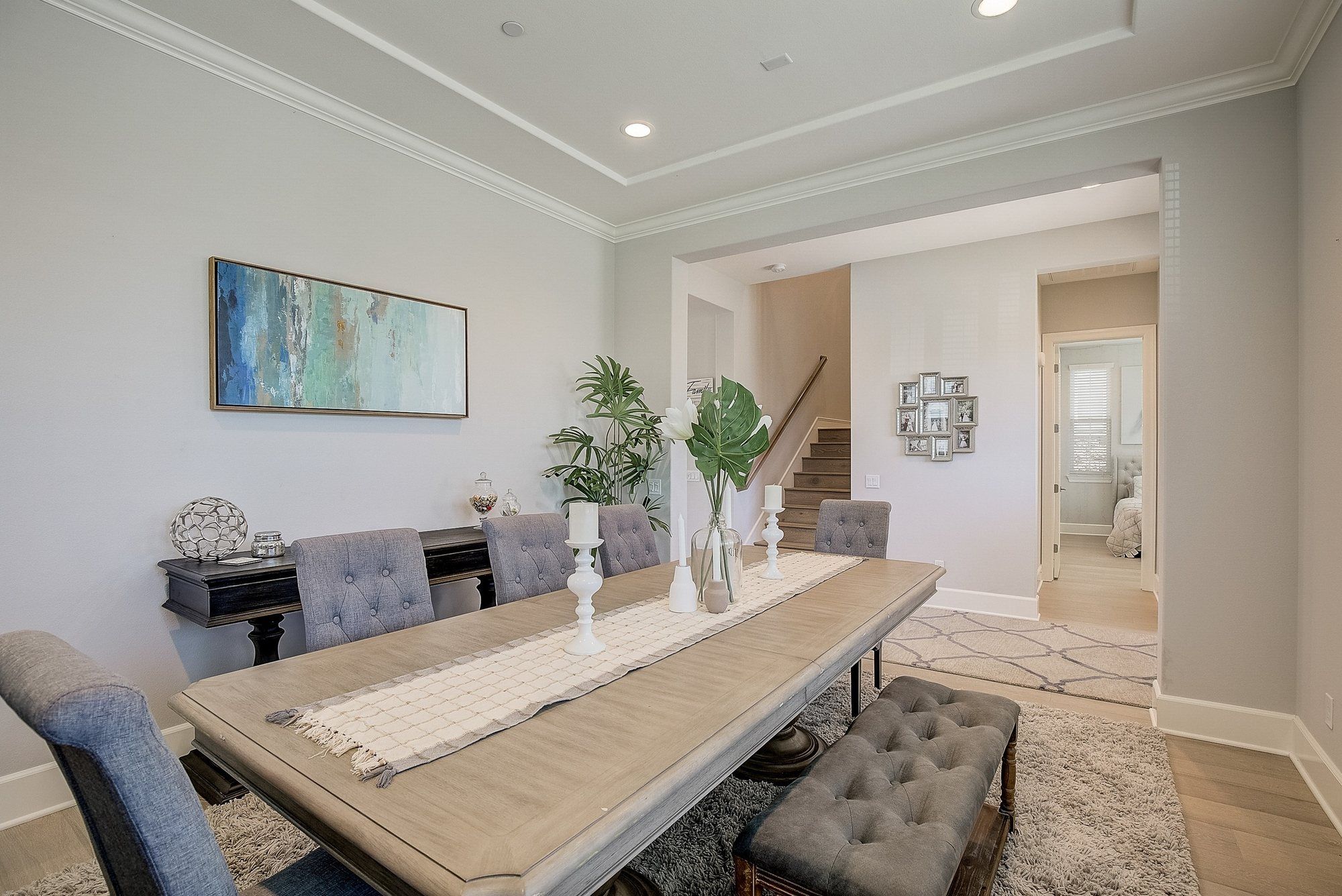 Formal dining room with a tufted bench and coastal art, Costa Mesa