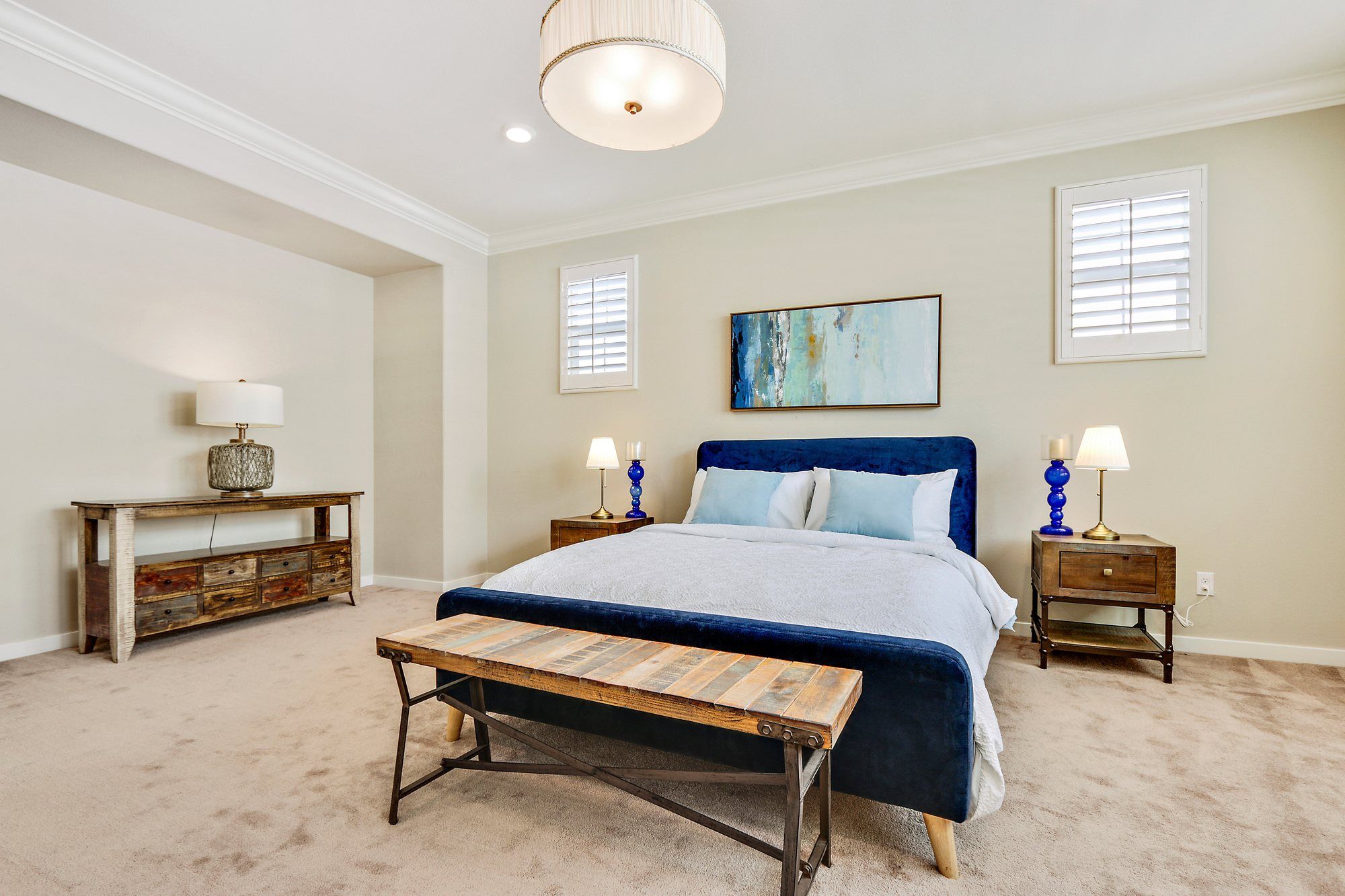 Navy bed with a wood bench at its foot, Irvine