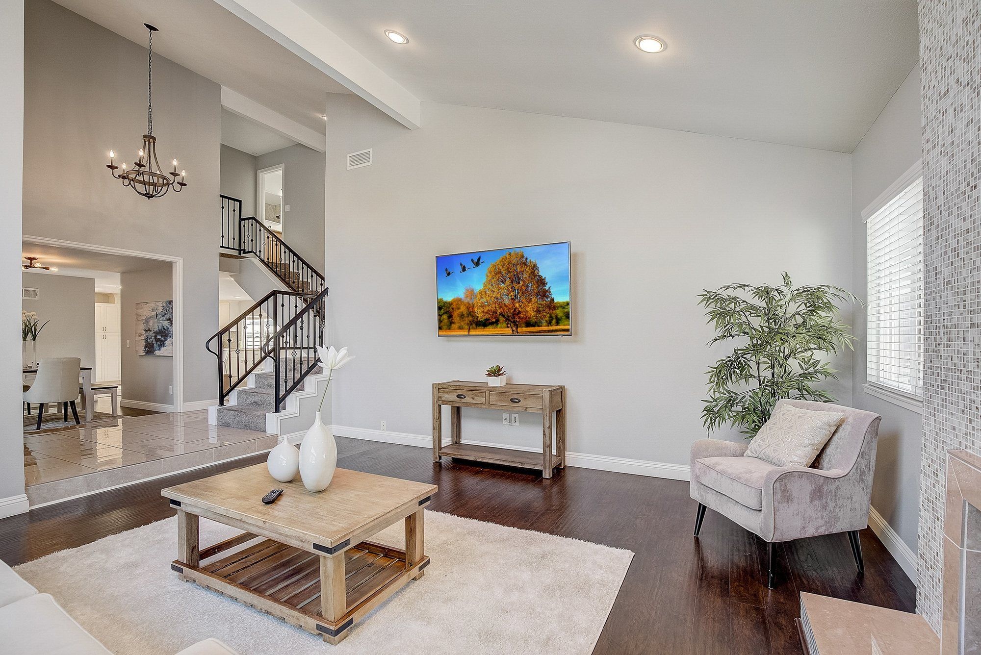 Living room under a vaulted ceiling, looking toward the staircase, Huntington Beach