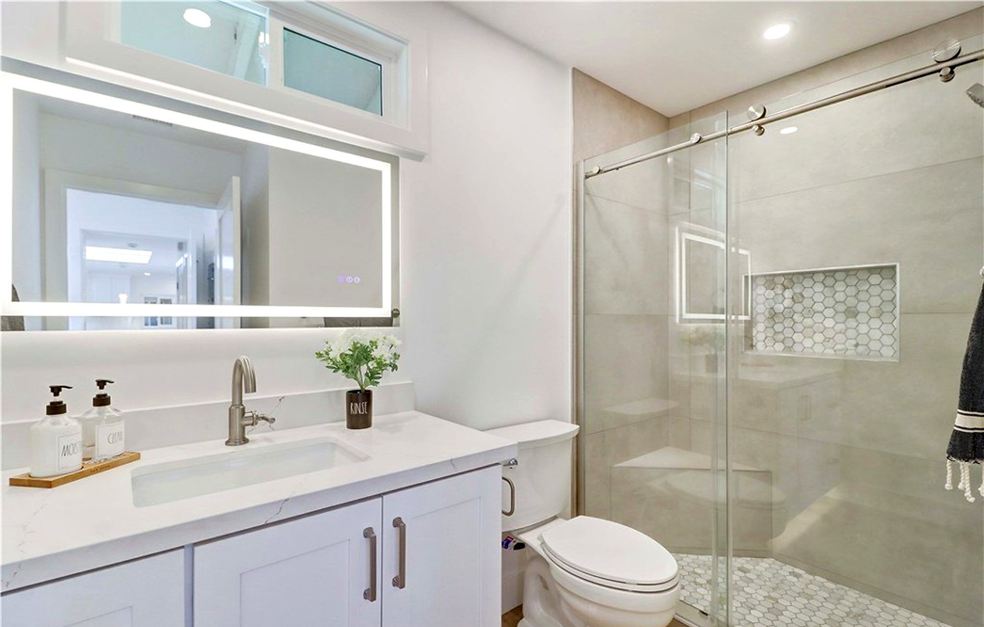 Bathroom with a lighted mirror and a glass shower, Laguna Woods
