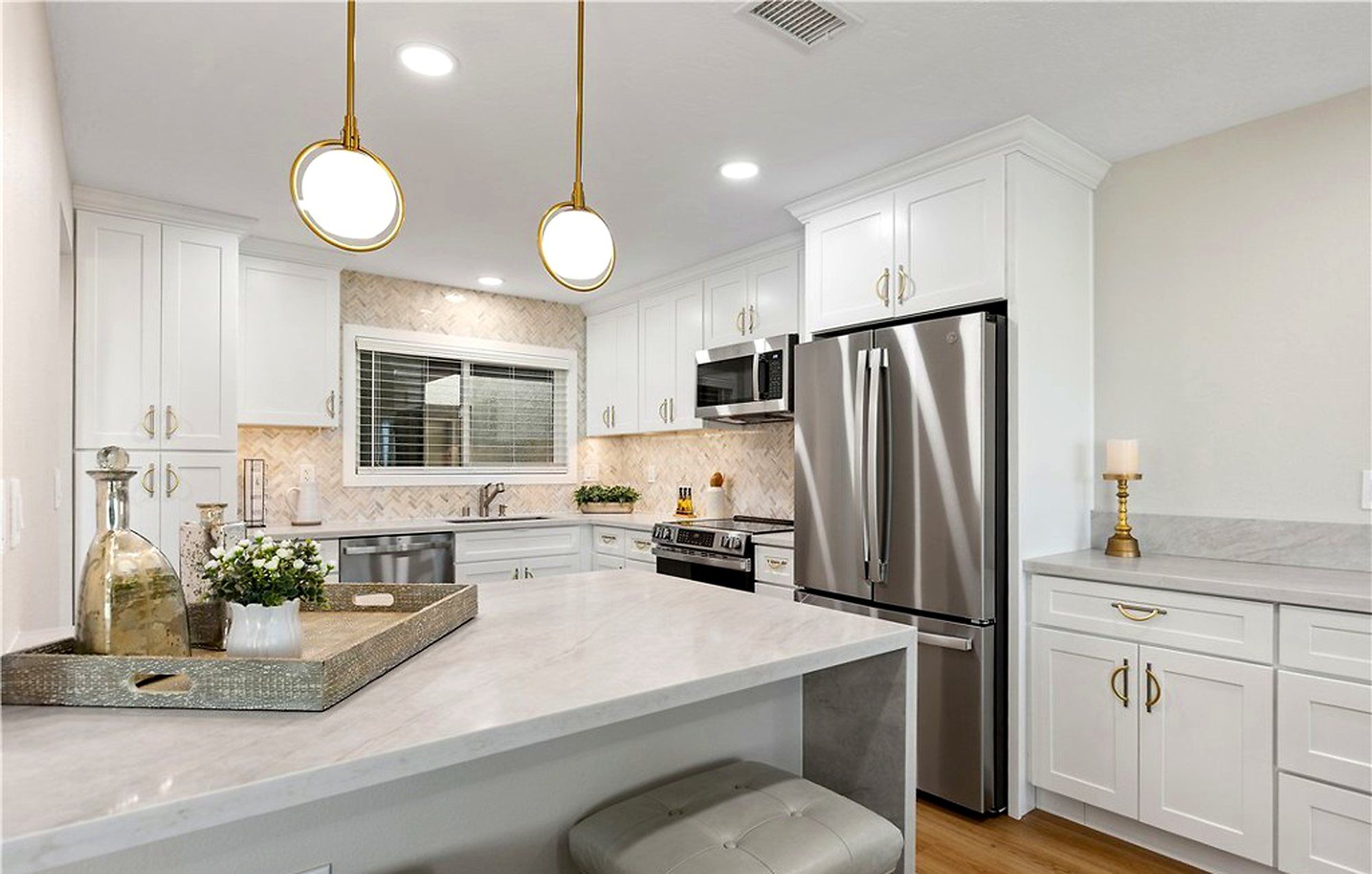 White shaker cabinets with brass hardware and stainless appliances, Laguna Woods