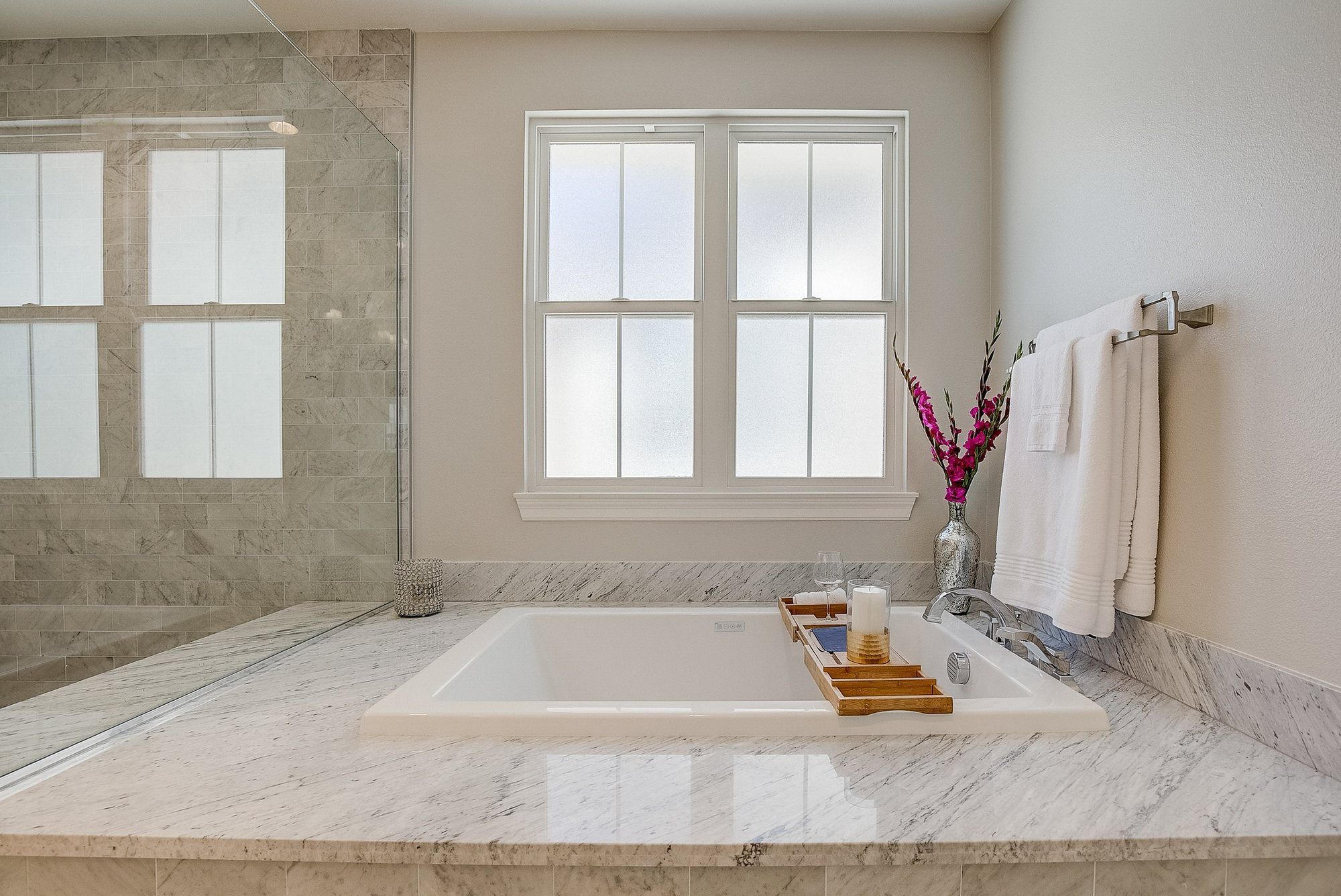 Soaking tub set in marble under shuttered windows, Costa Mesa