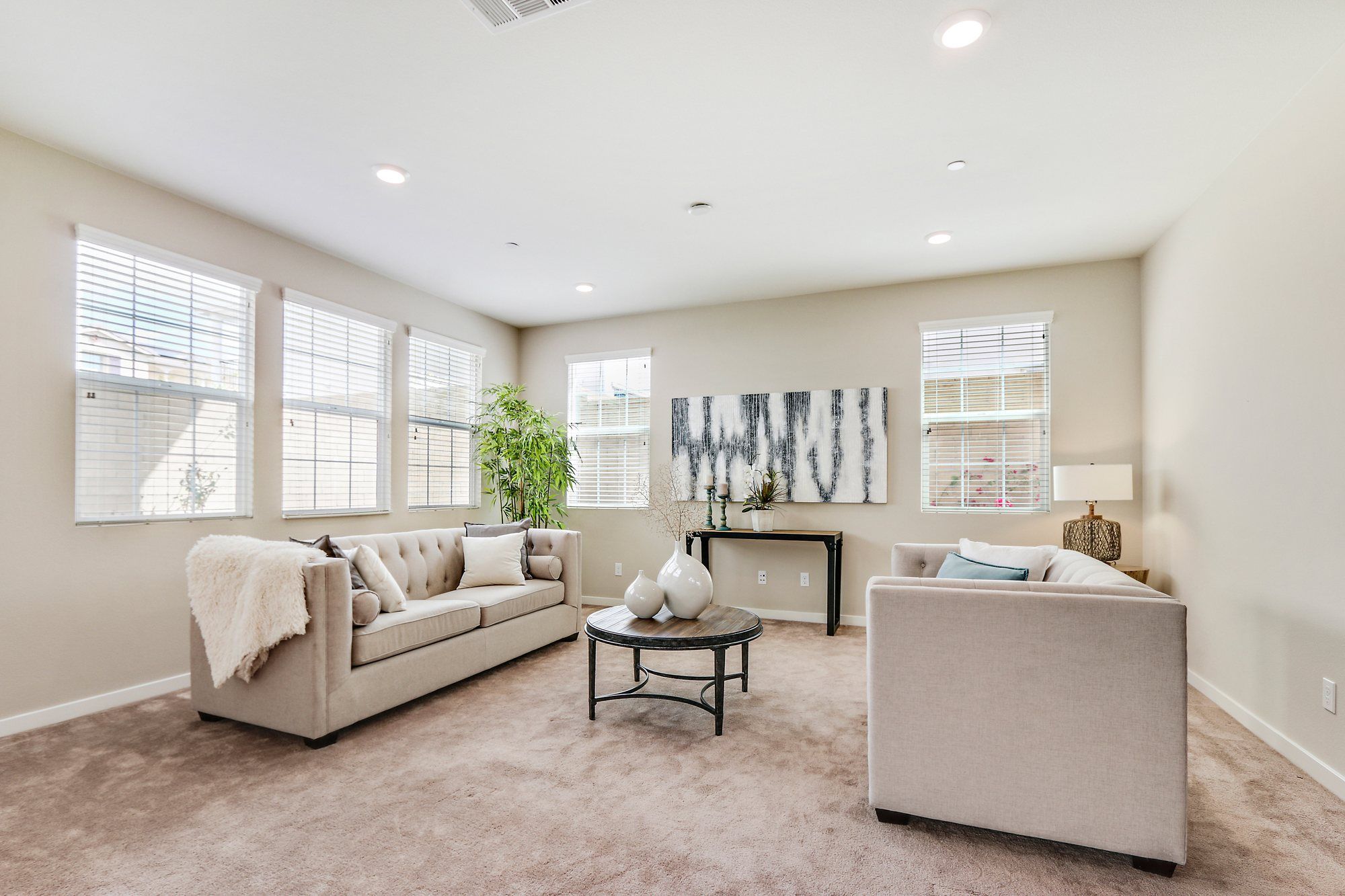 Family room with two light sofas and a round coffee table, Irvine