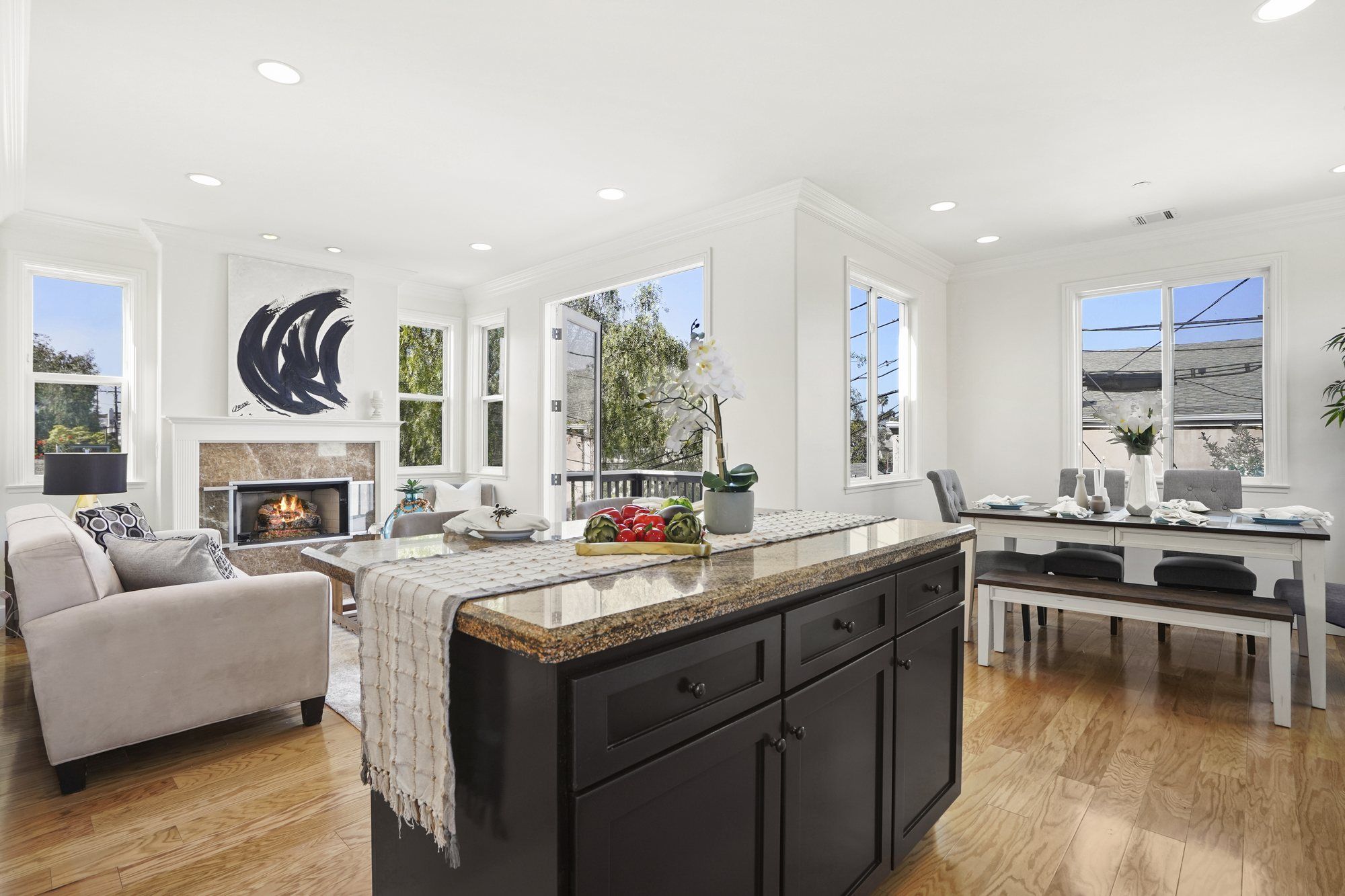 Dark kitchen island with the dining table by the windows, Newport Beach