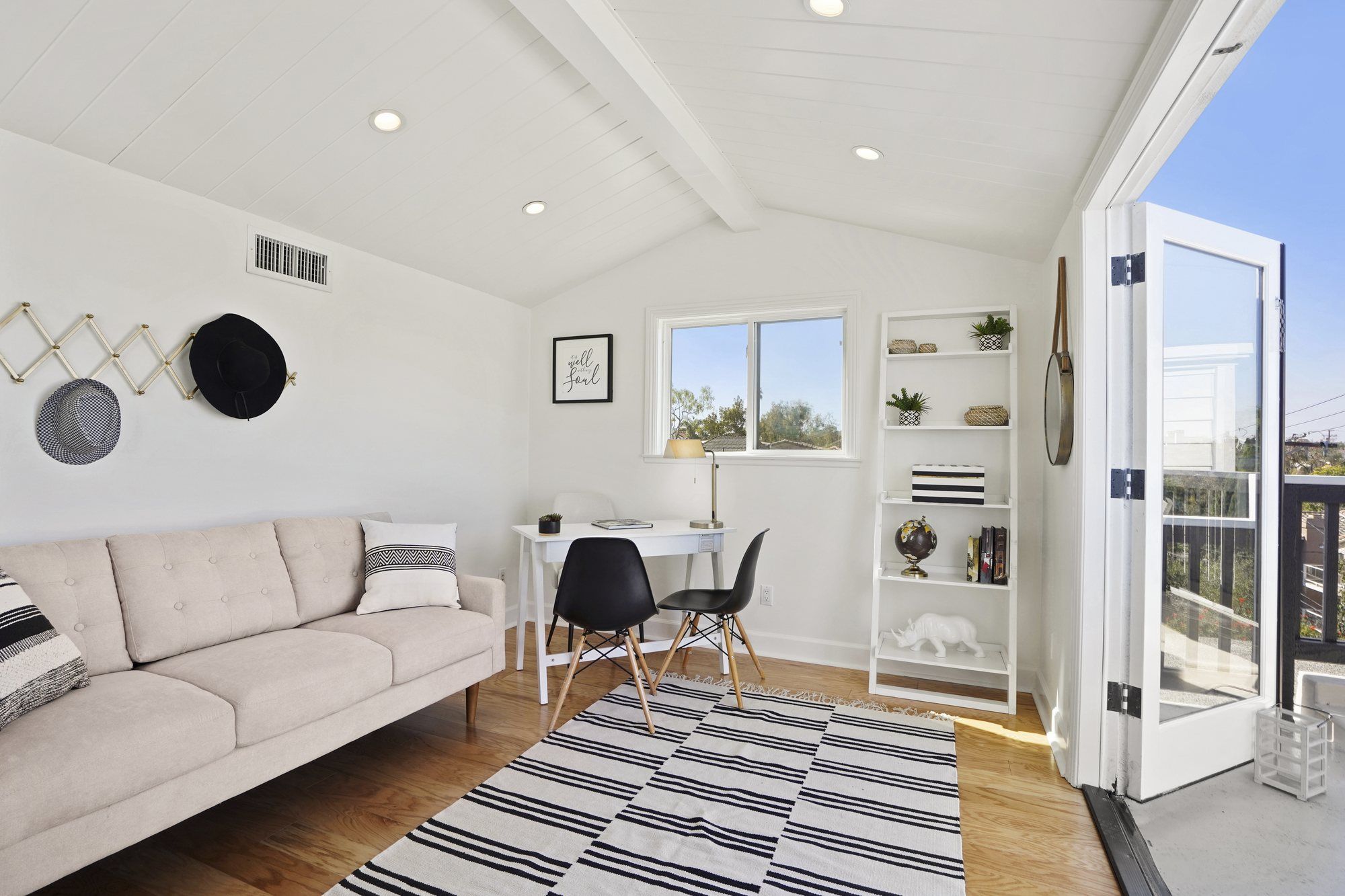 Top-floor room with a sofa, a striped rug and a small desk, Newport Beach