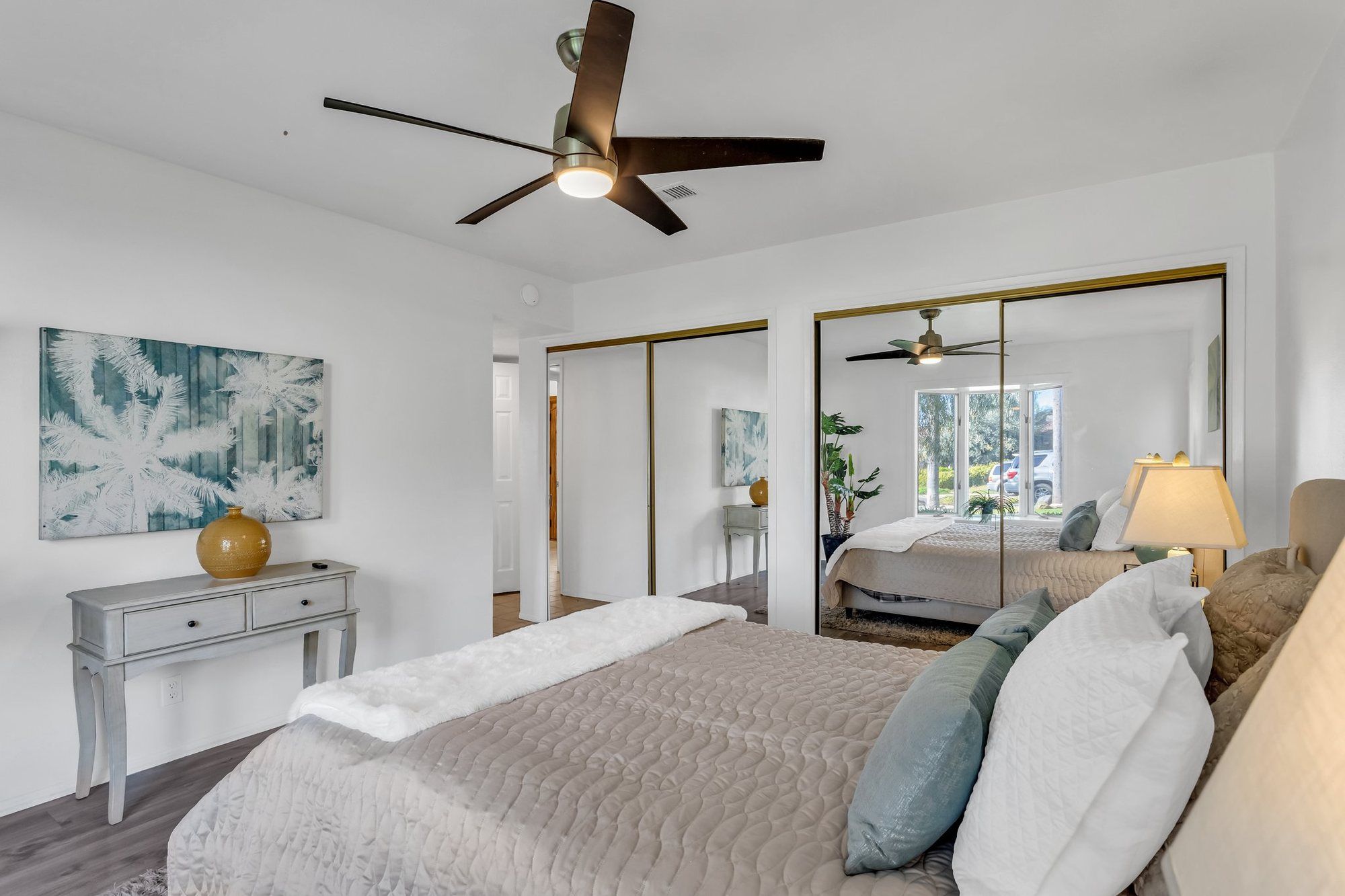 Bedroom with a console table and mirrored closet doors, Tustin