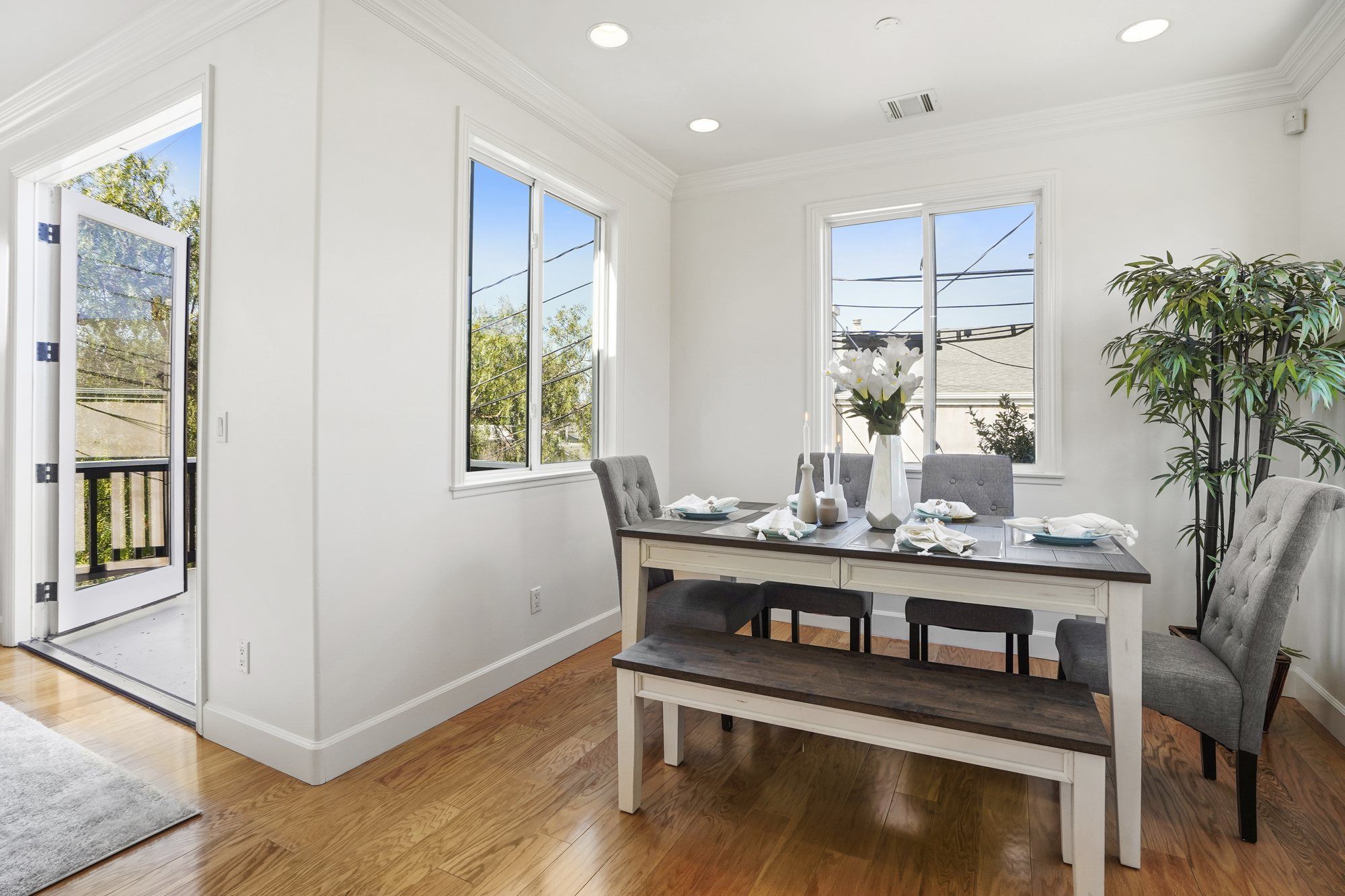 Dining table with a bench beside the balcony door, Newport Beach
