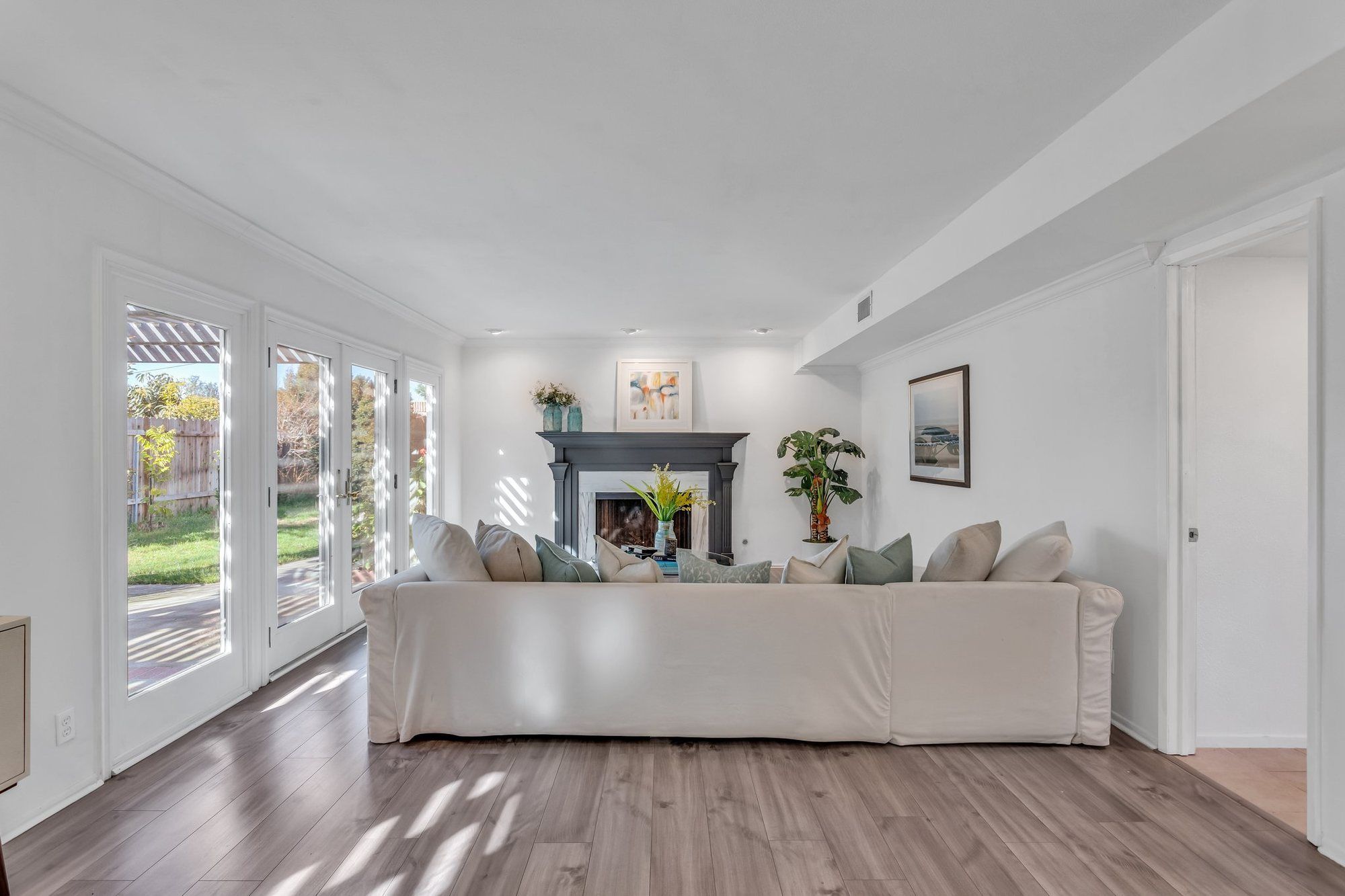 Long white sofa facing the fireplace, Tustin