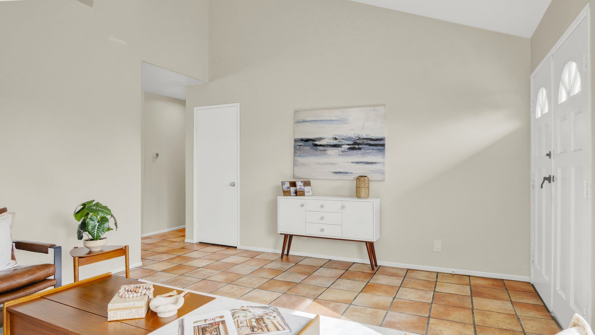 Entry with a white console and seascape art, Dana Point