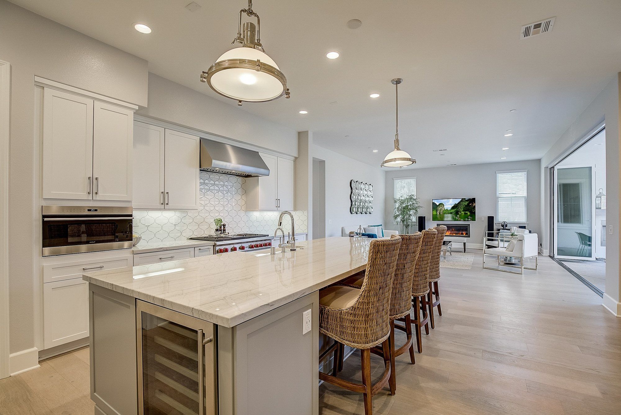 Kitchen island with four woven stools, open to the great room, Costa Mesa