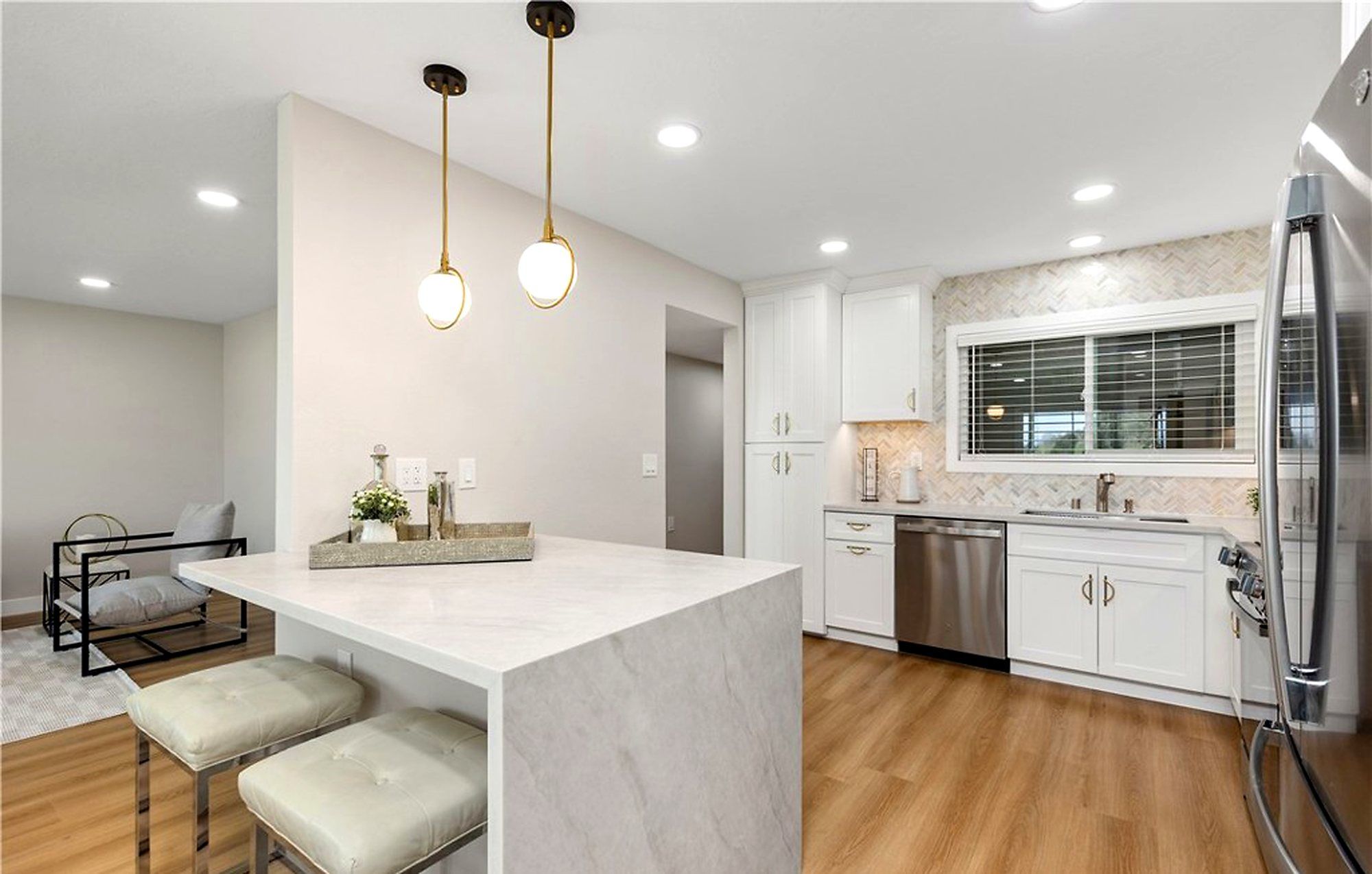 Kitchen peninsula with two stools and brass pendant lights, Laguna Woods