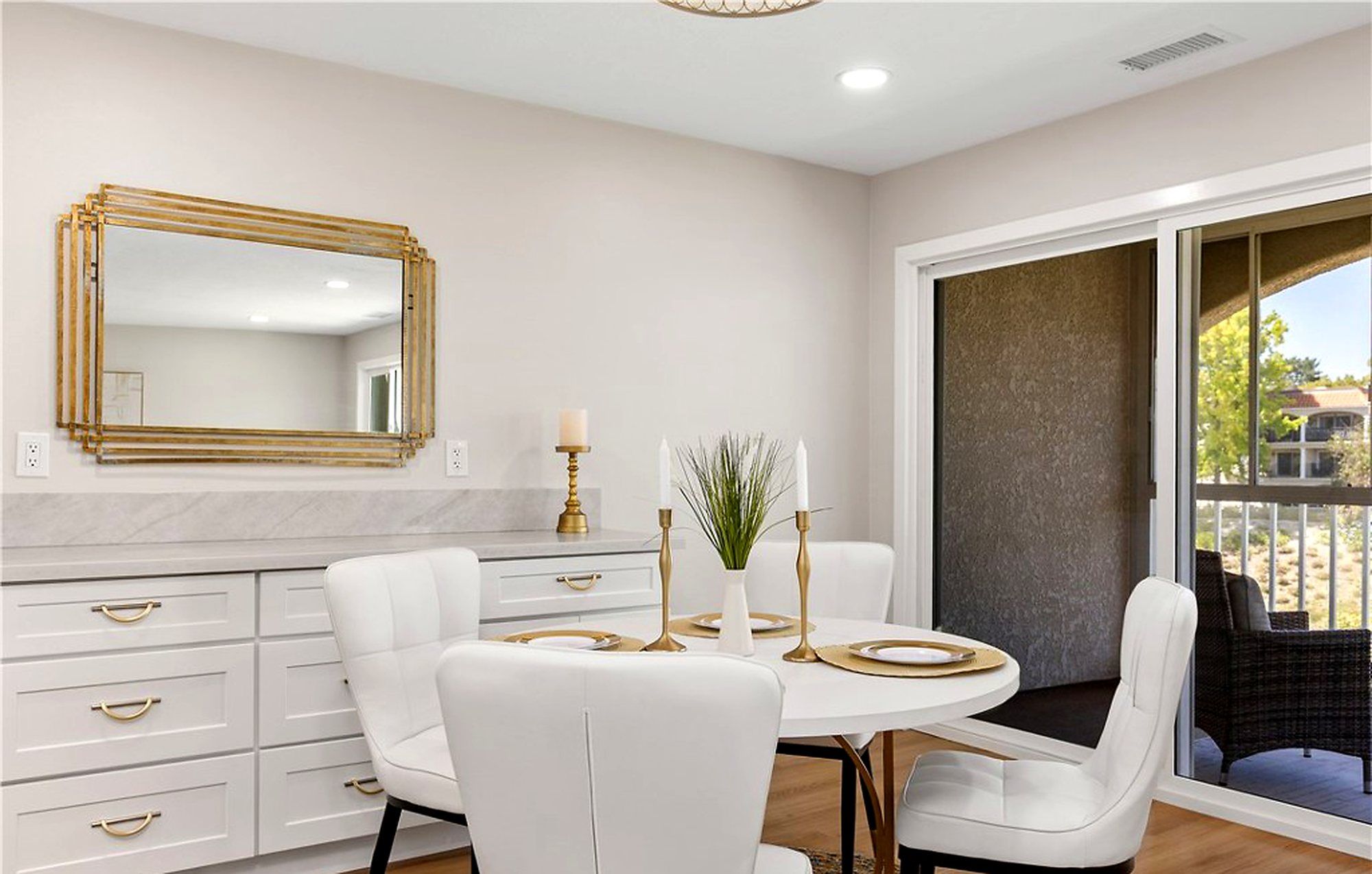 Dining table under a gold-framed mirror, next to the balcony door, Laguna Woods
