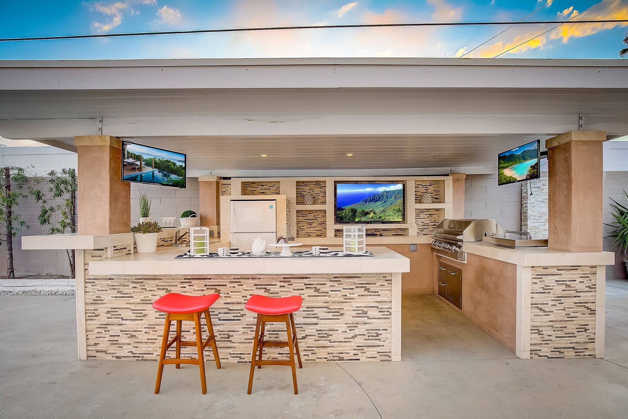 Outdoor bar with stone tile and red stools, Huntington Beach