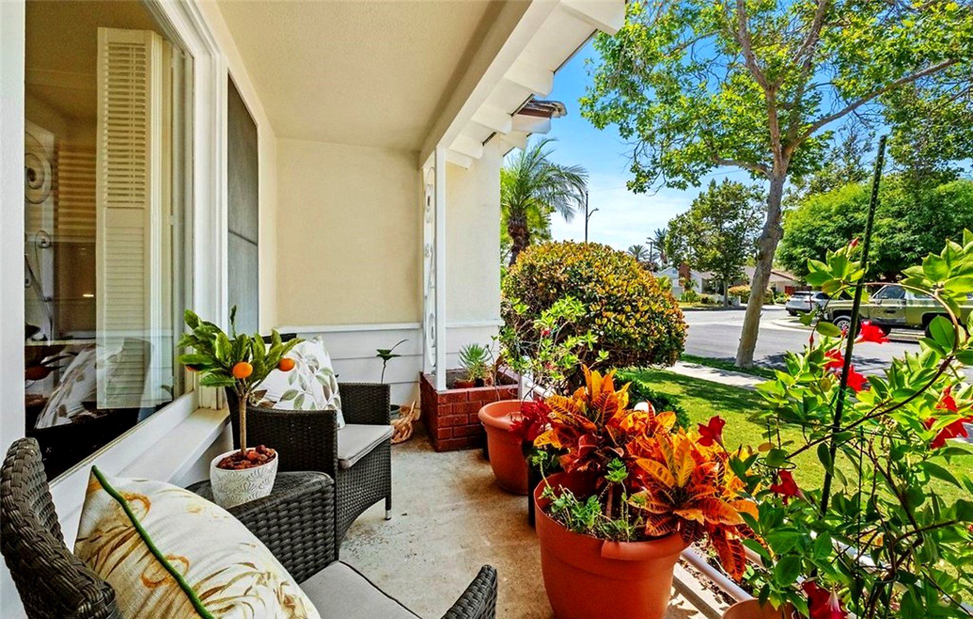 Front porch with wicker seating and potted plants, Santa Ana