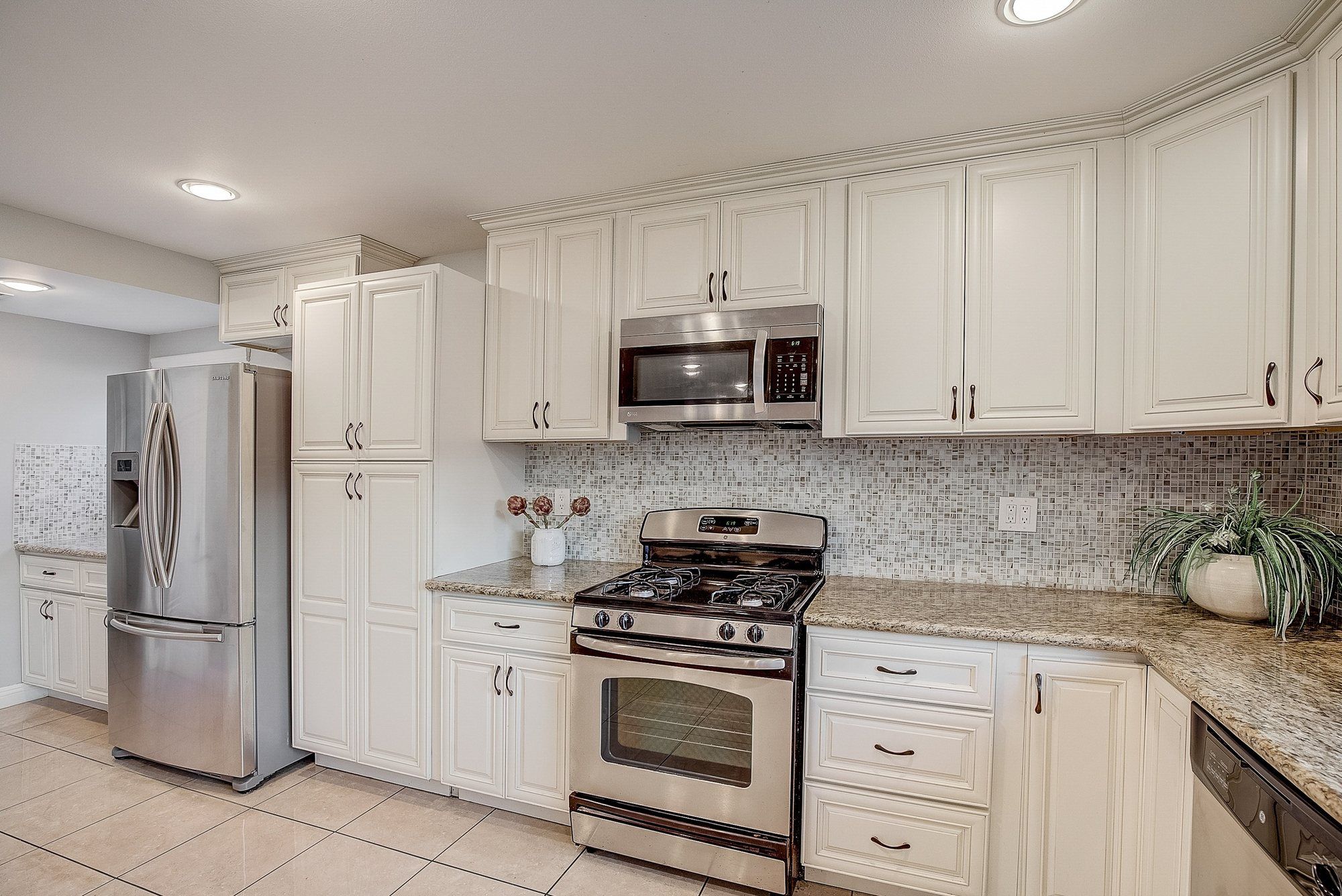 Cream cabinets around a stainless range, Huntington Beach