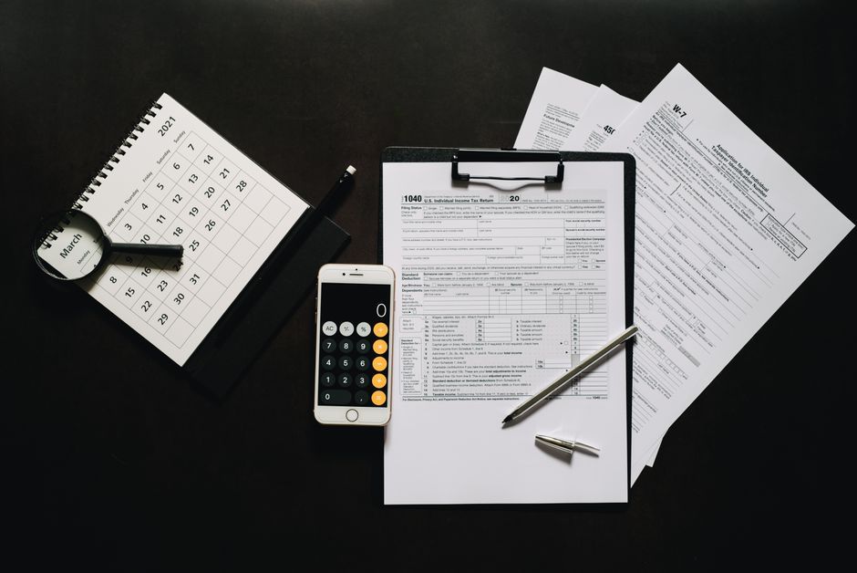 calculator and tax forms on desk