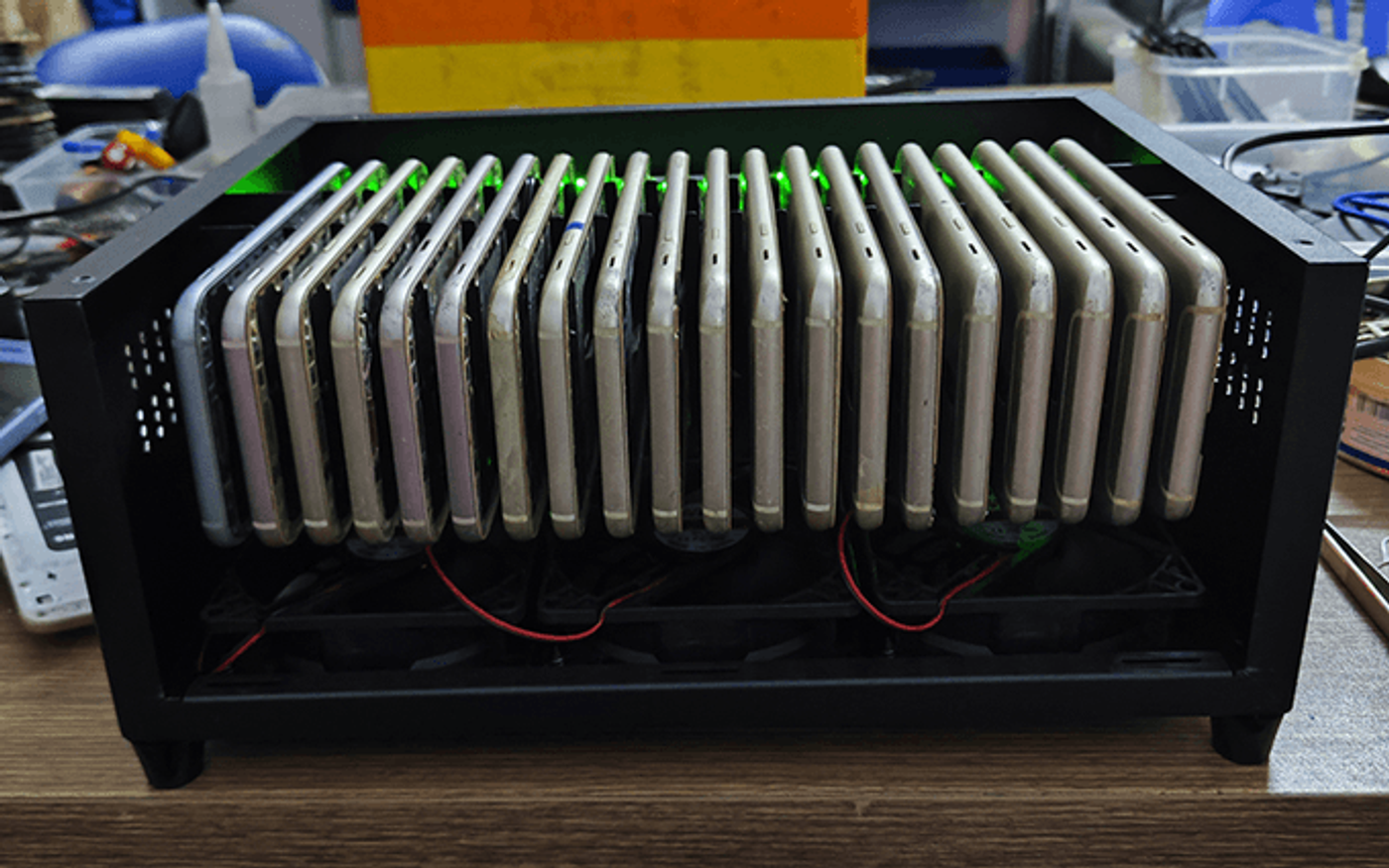 A rack of real Android phones standing side by side in a cooling enclosure